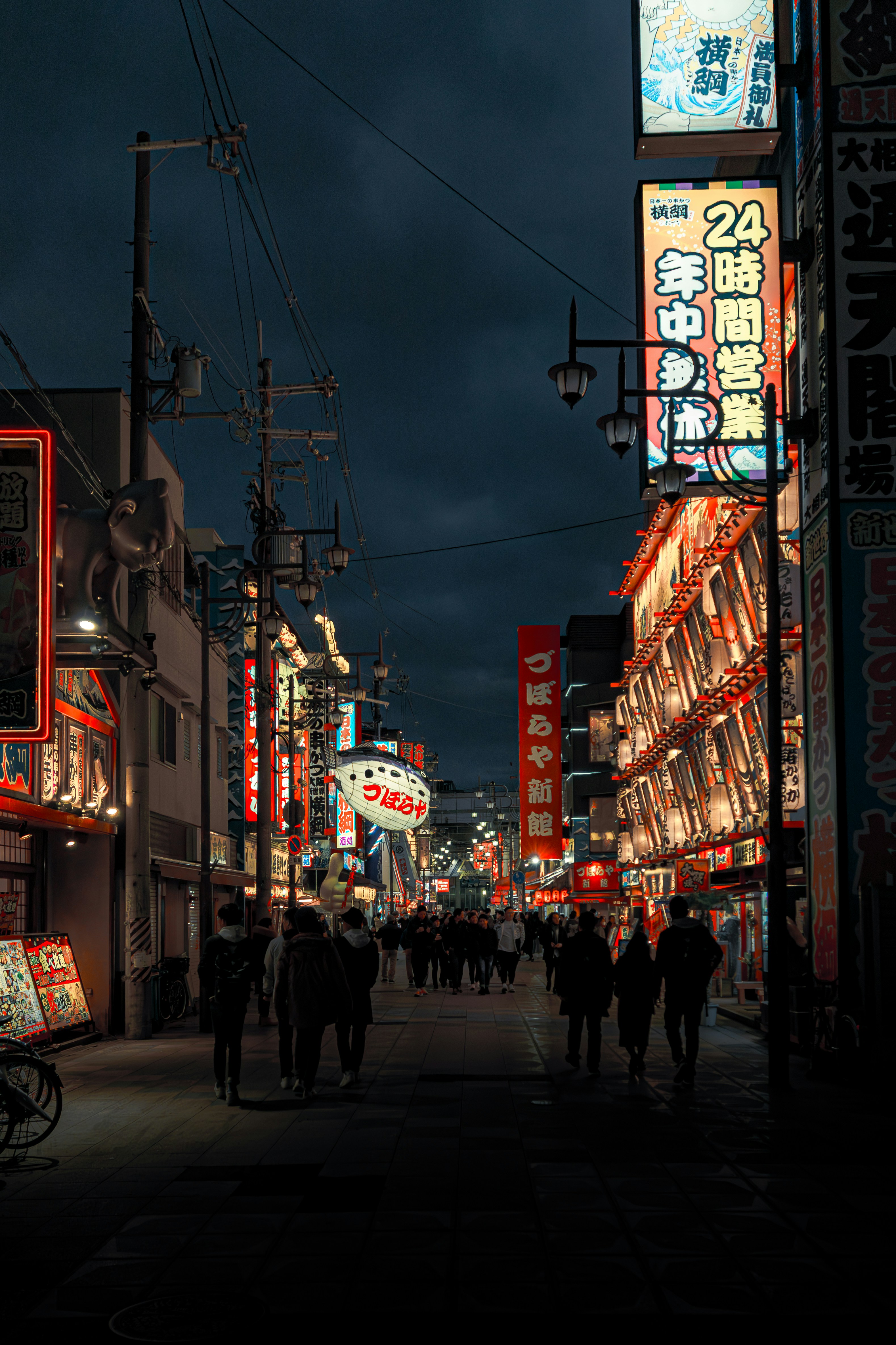 Busy street with glowing neon signs at night