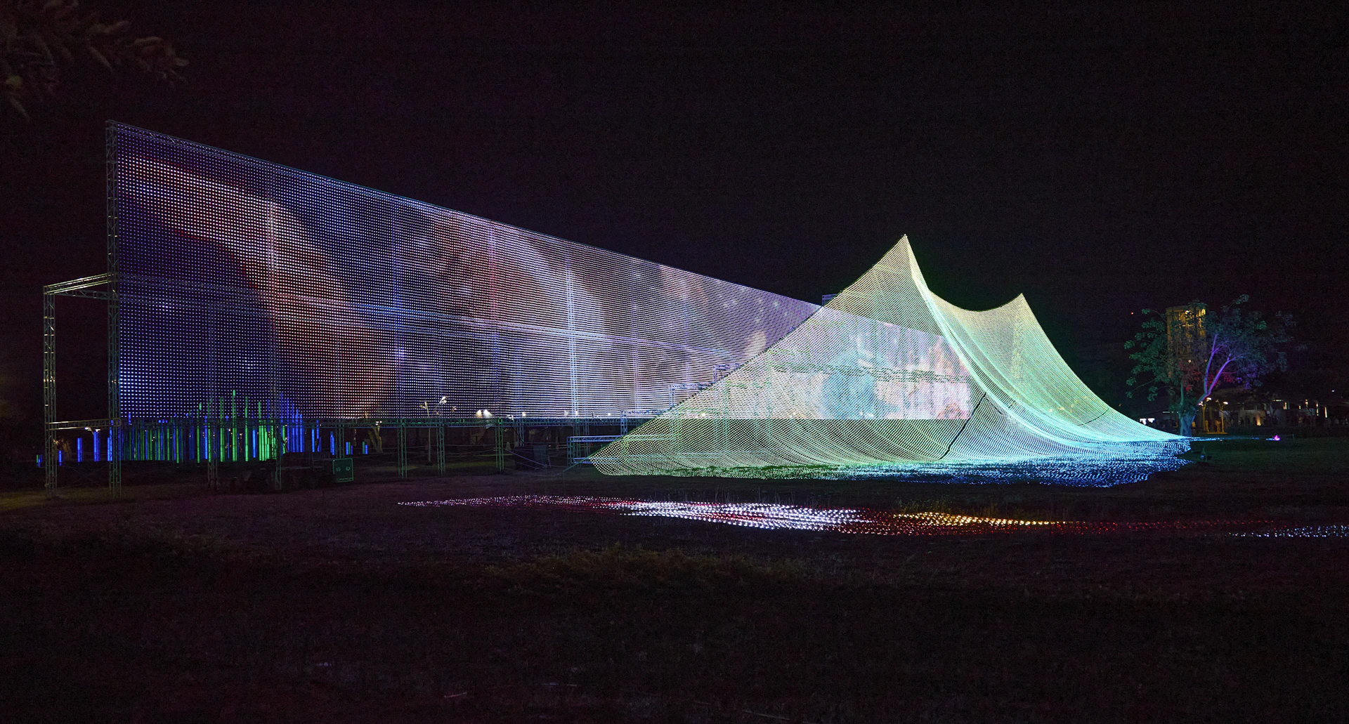 Building illuminated with colorful projections at night