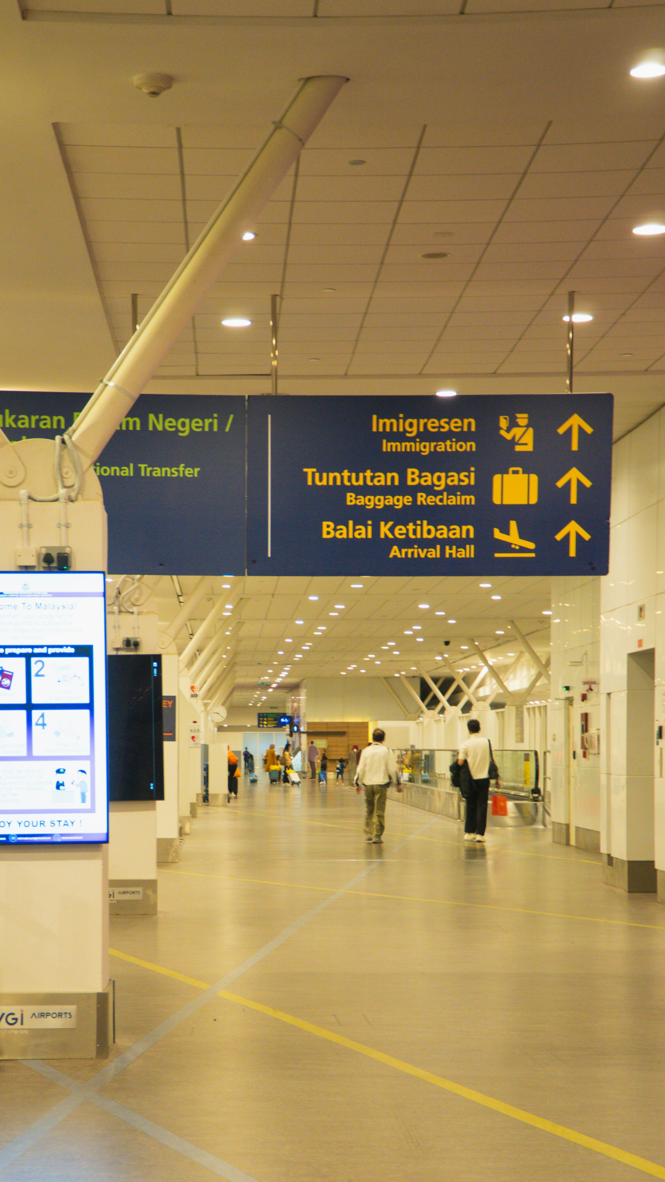 Driver holding a sign with a passenger's name at the airport arrival hall