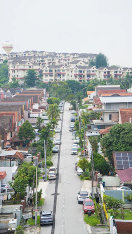Residential street lined with houses and parked cars