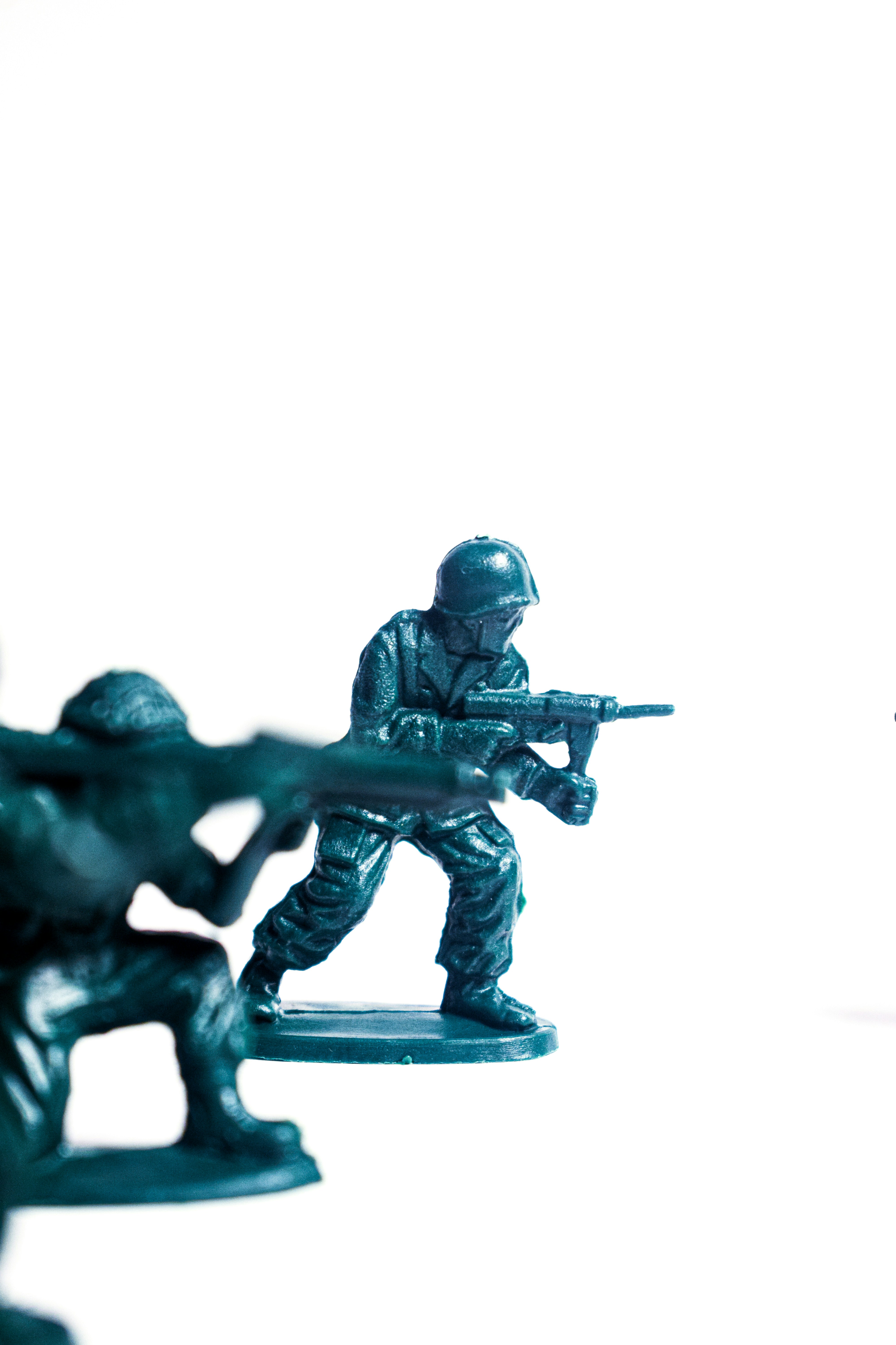 Green toy soldiers in action on white background