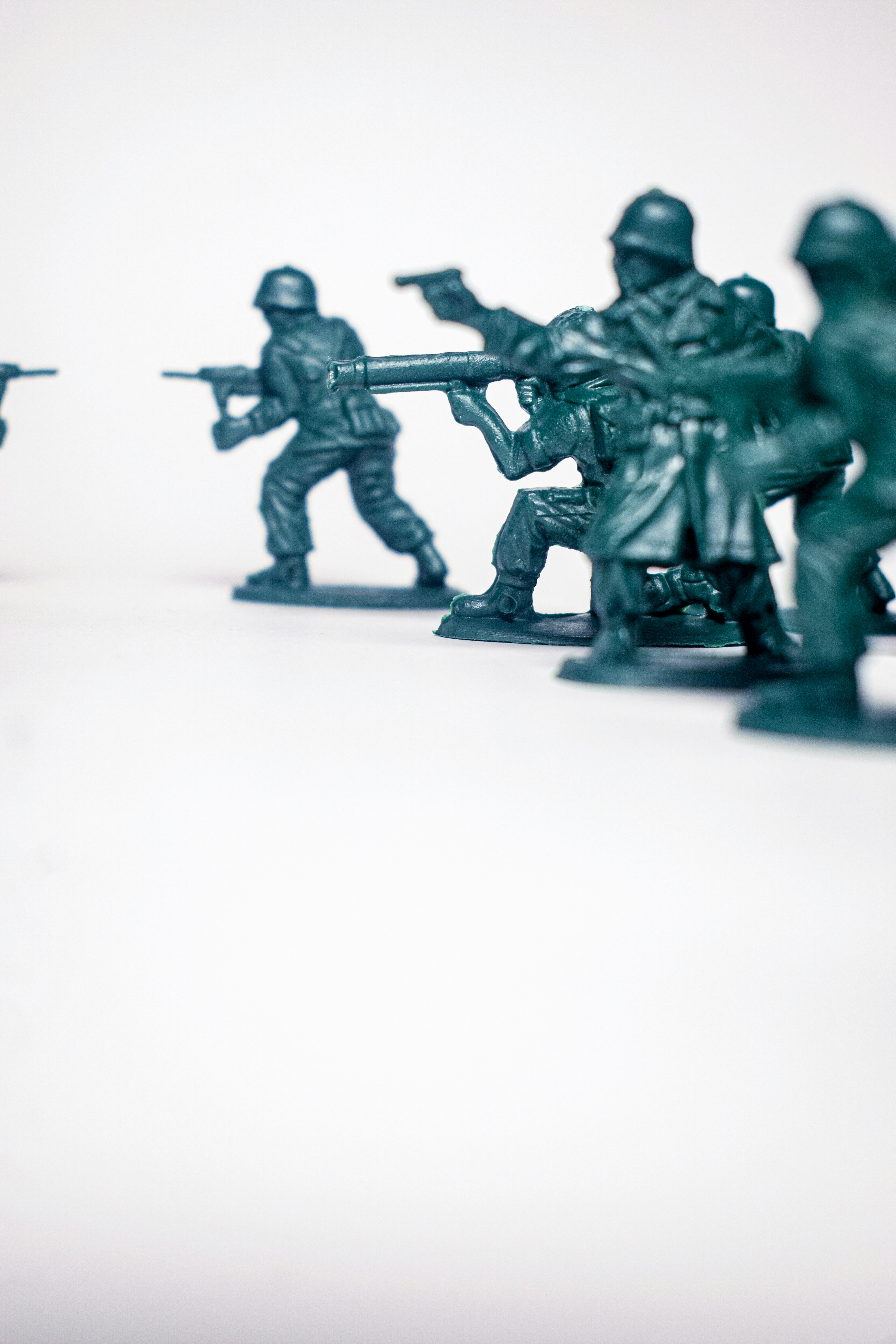Green toy soldiers in a line with guns