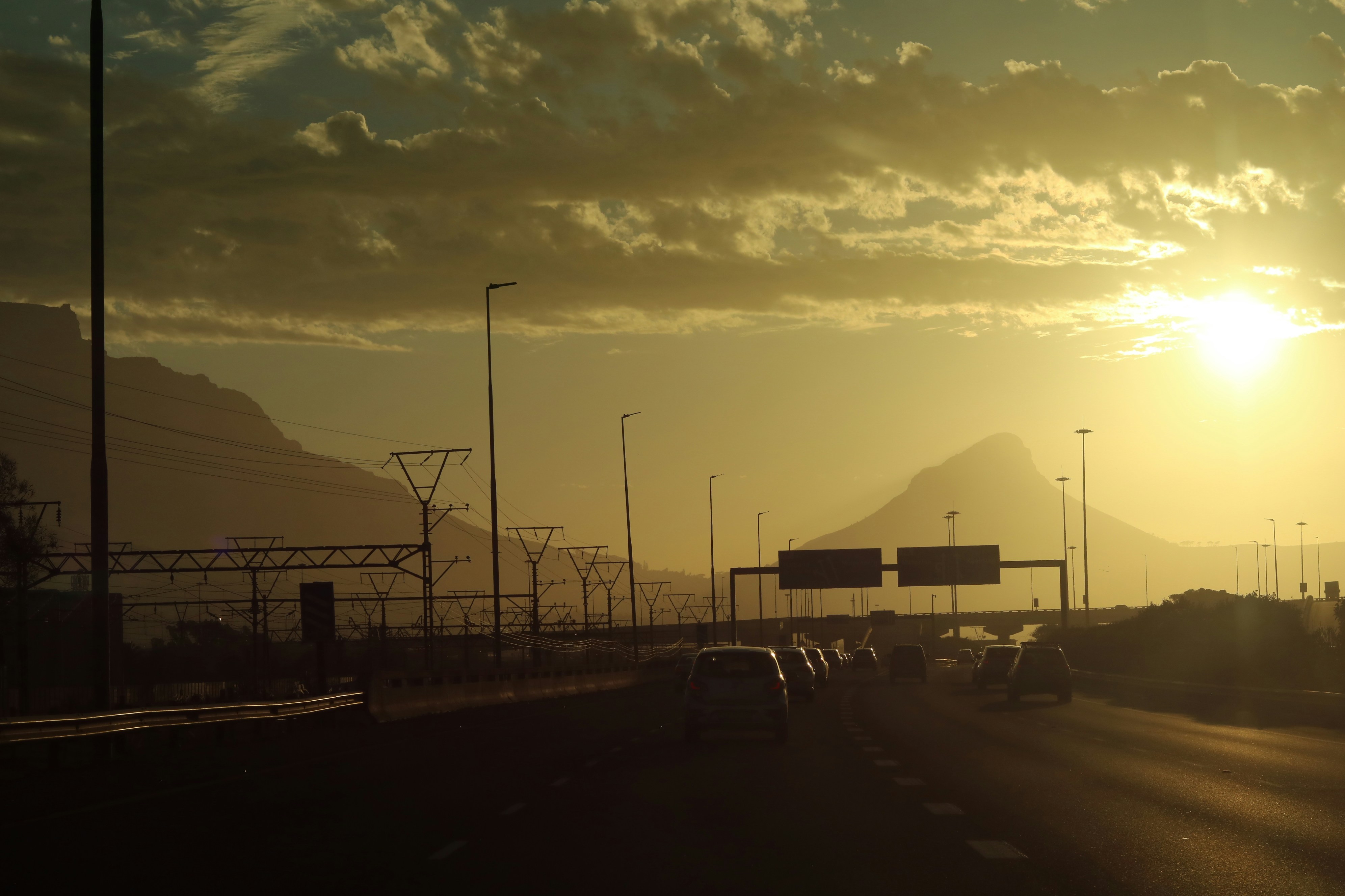 Sunset over a highway with mountains in the background in South Africa