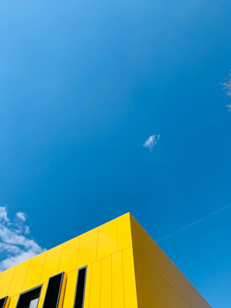 Bright yellow building against a clear blue sky