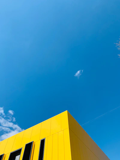 Bright yellow building against a clear blue sky