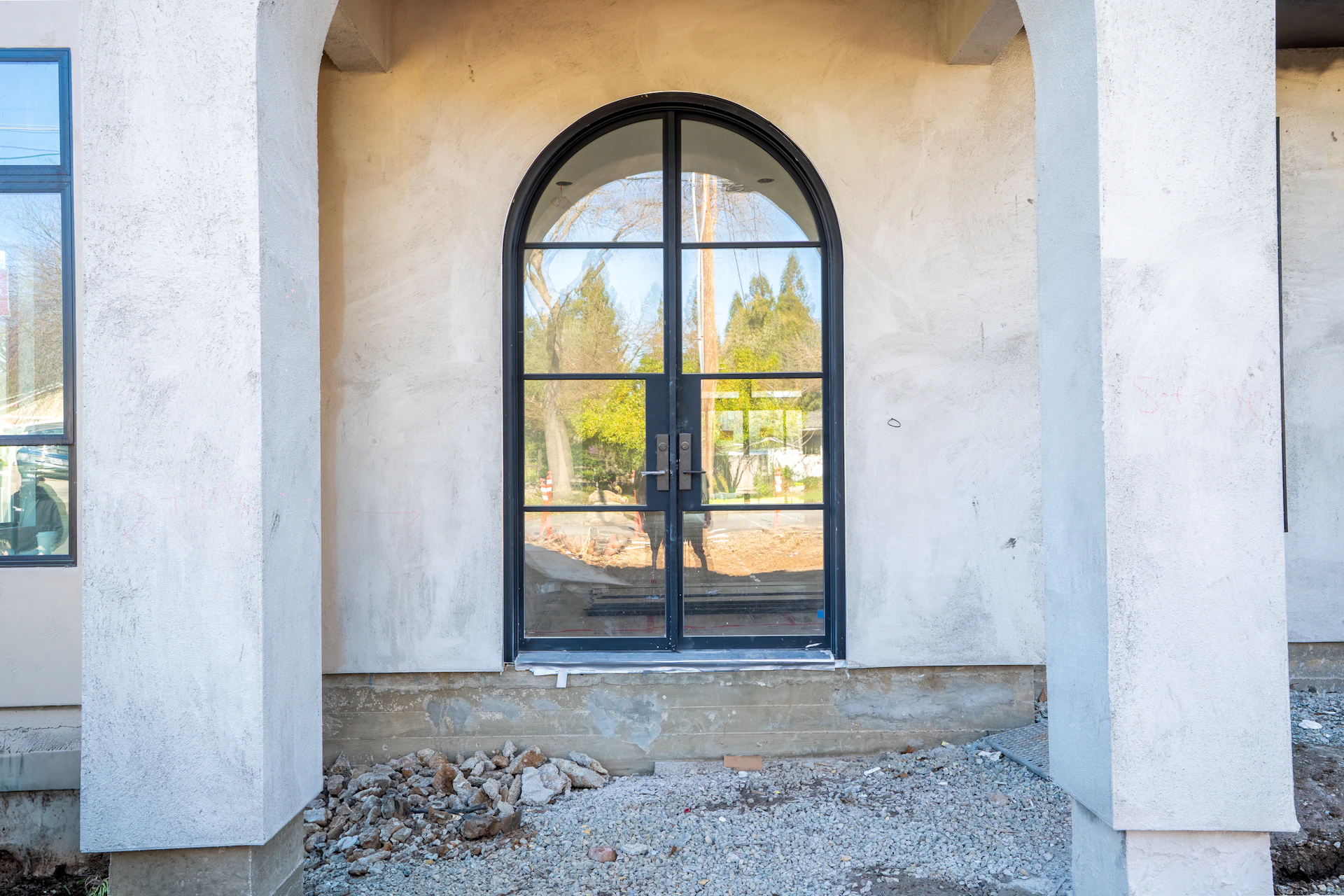 Arched glass double doors with black metal frames