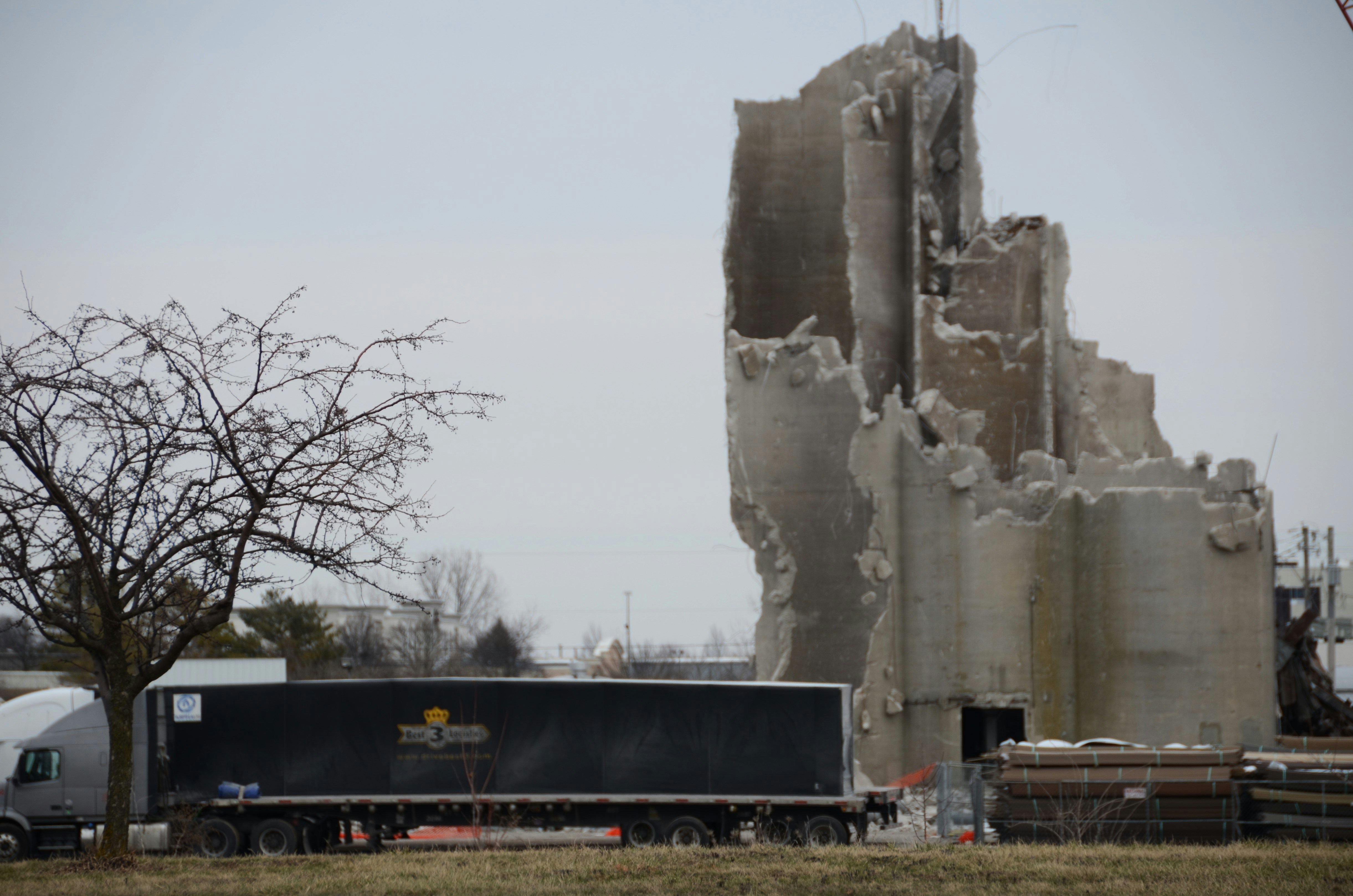 Demolished concrete structure next to a semi-trailer truck