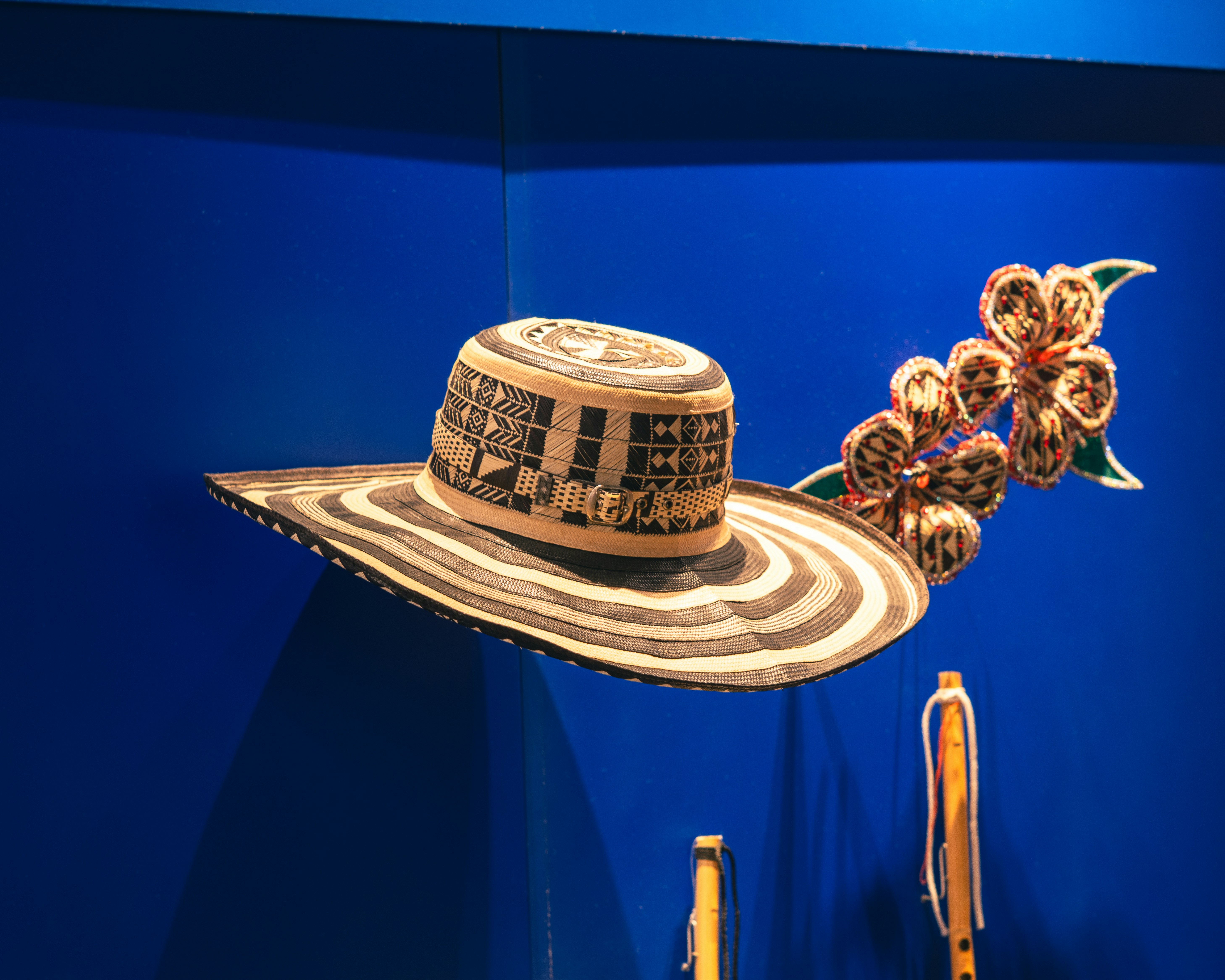 A wide-brimmed hat with floral decoration on blue