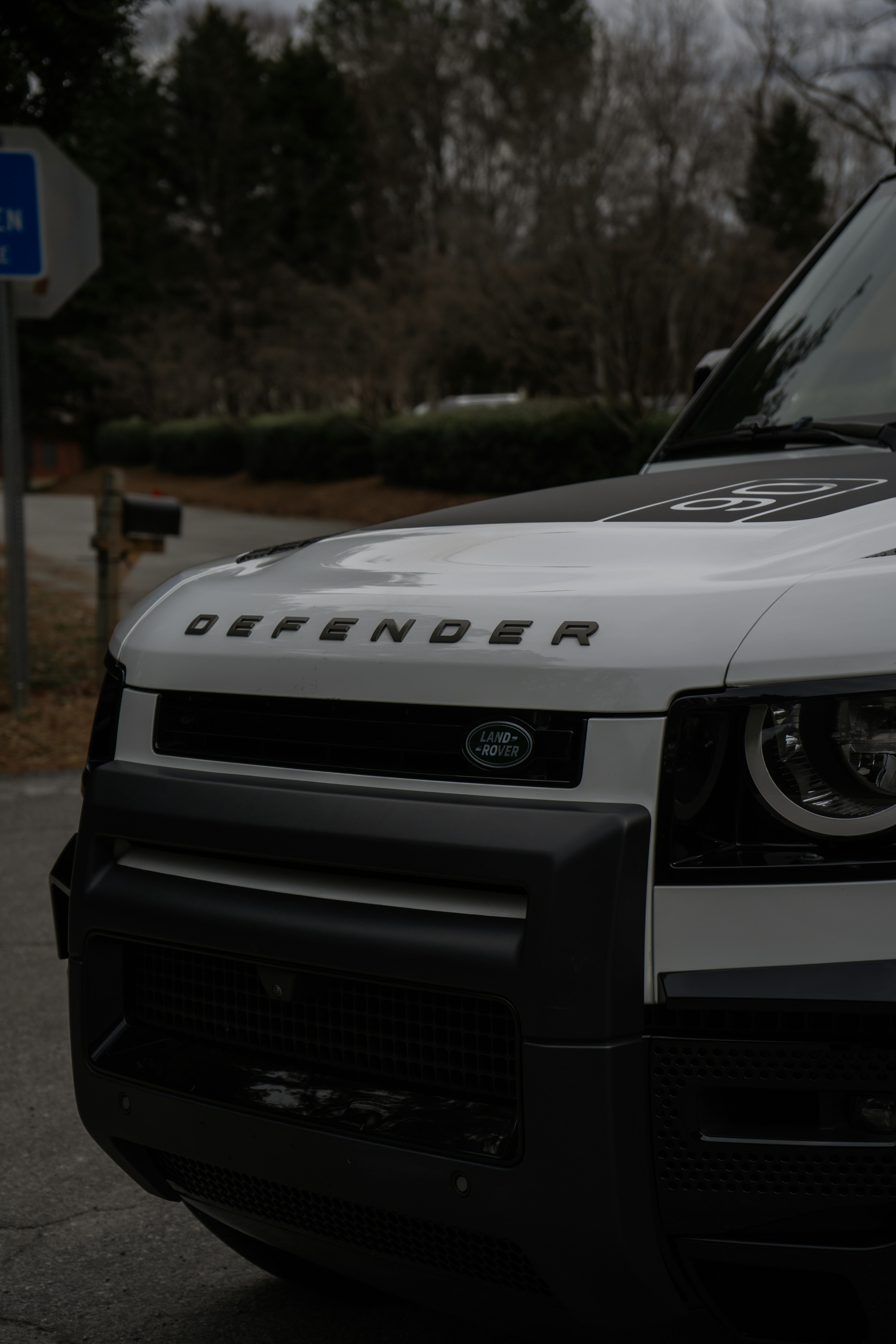 White land rover defender parked outdoors