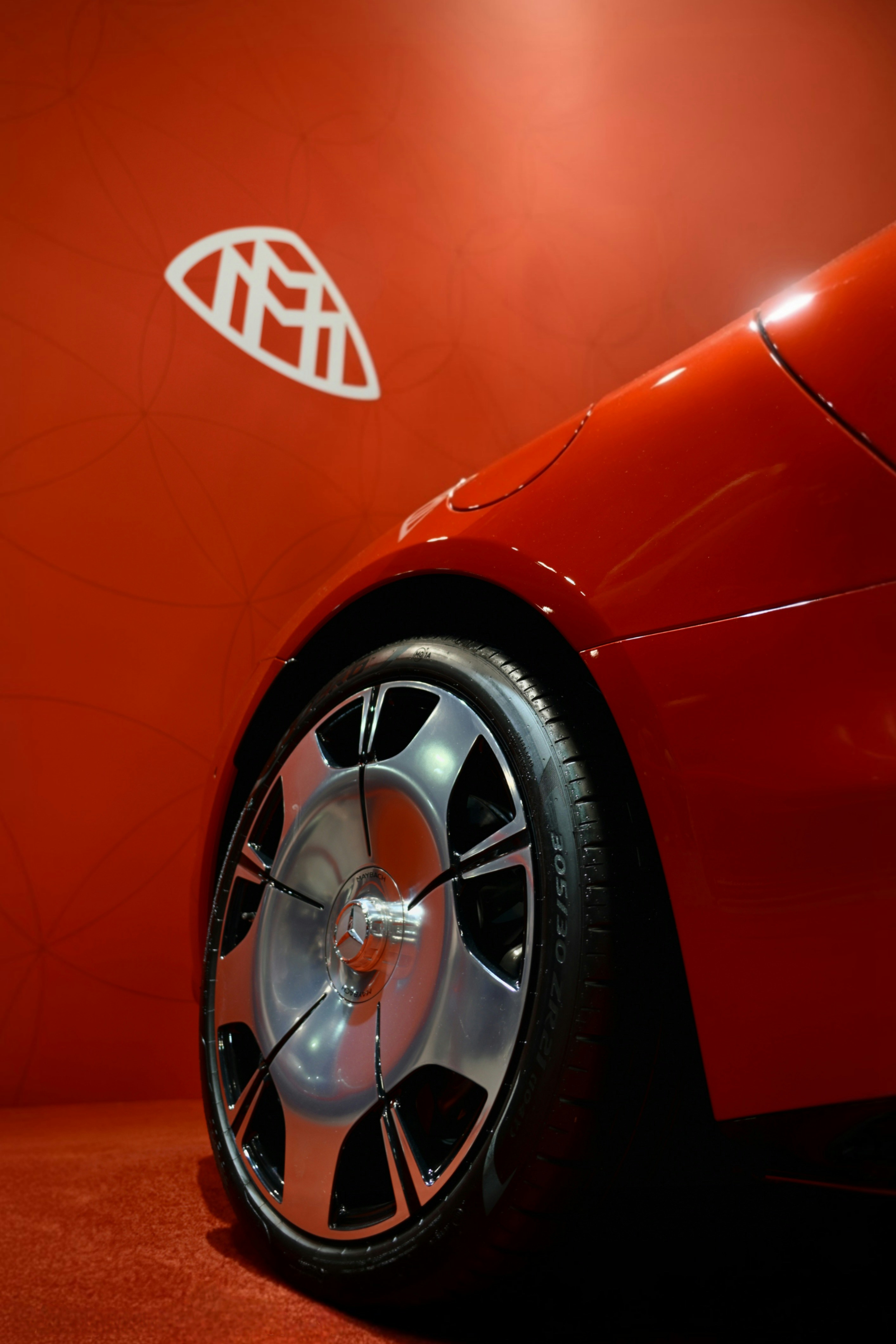 Red luxury car with maybach logo