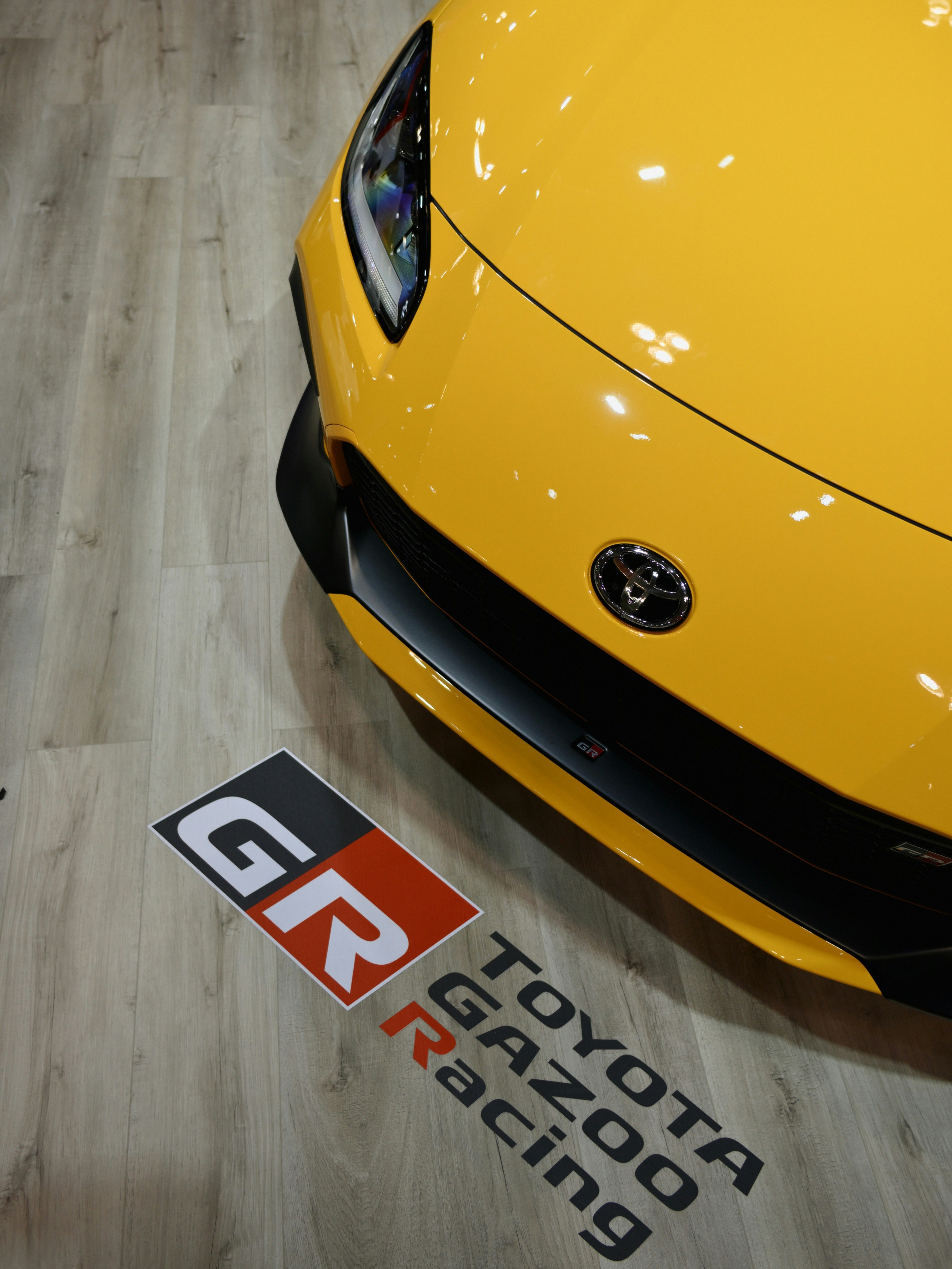 Yellow toyota gr sports car with racing logo