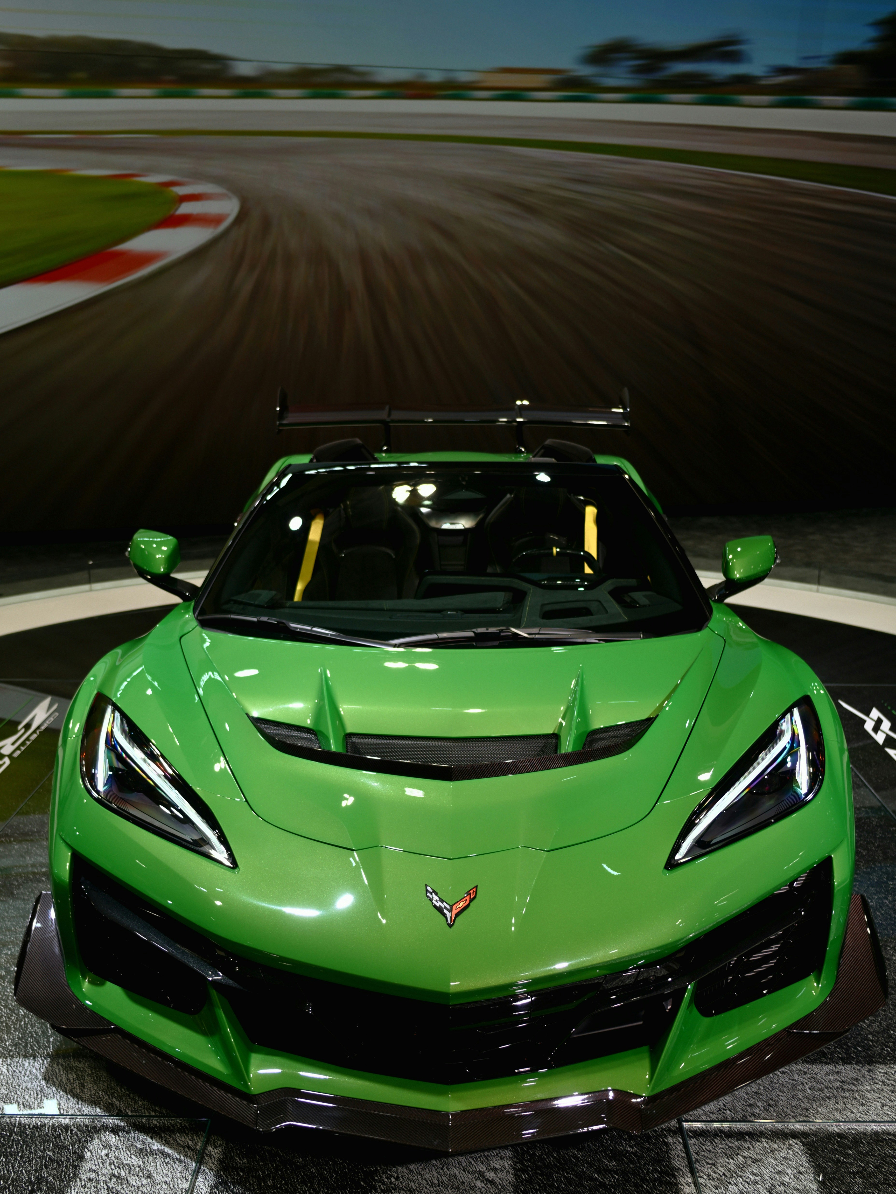 A bright green sports car on a race track.