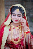 A beautiful bride in traditional indian attire and jewelry.