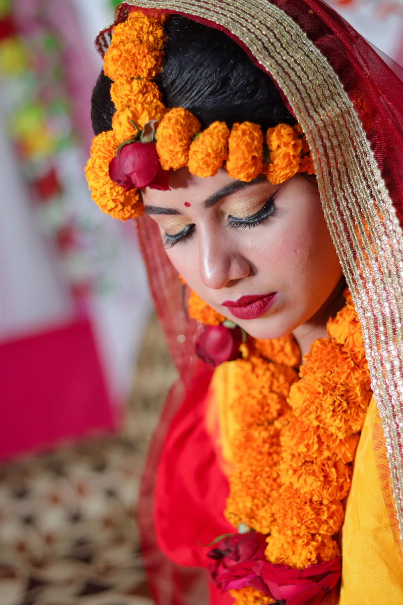 Bride adorned with marigold flowers and traditional jewellery at an RK Events wedding