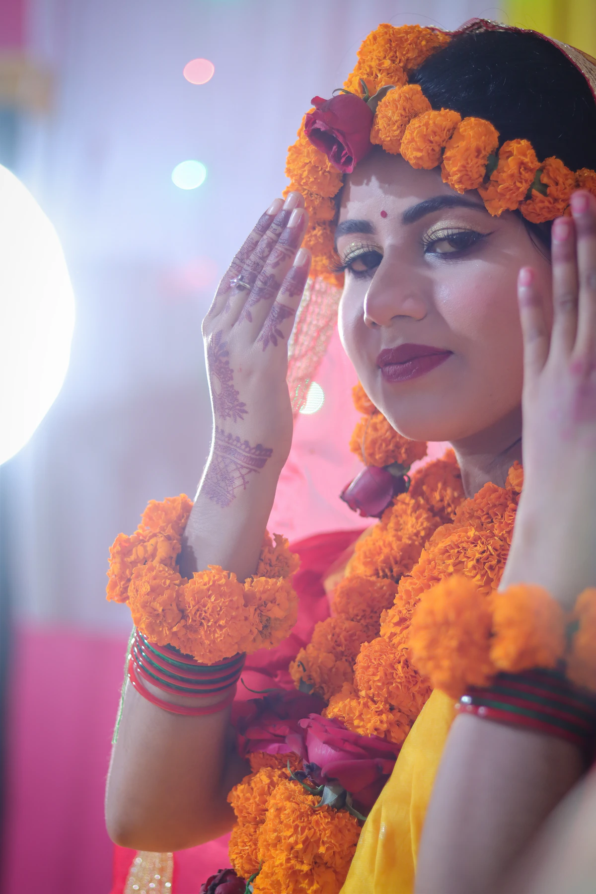 Indian bride wearing marigold flowers during a joyful Haldi ceremony