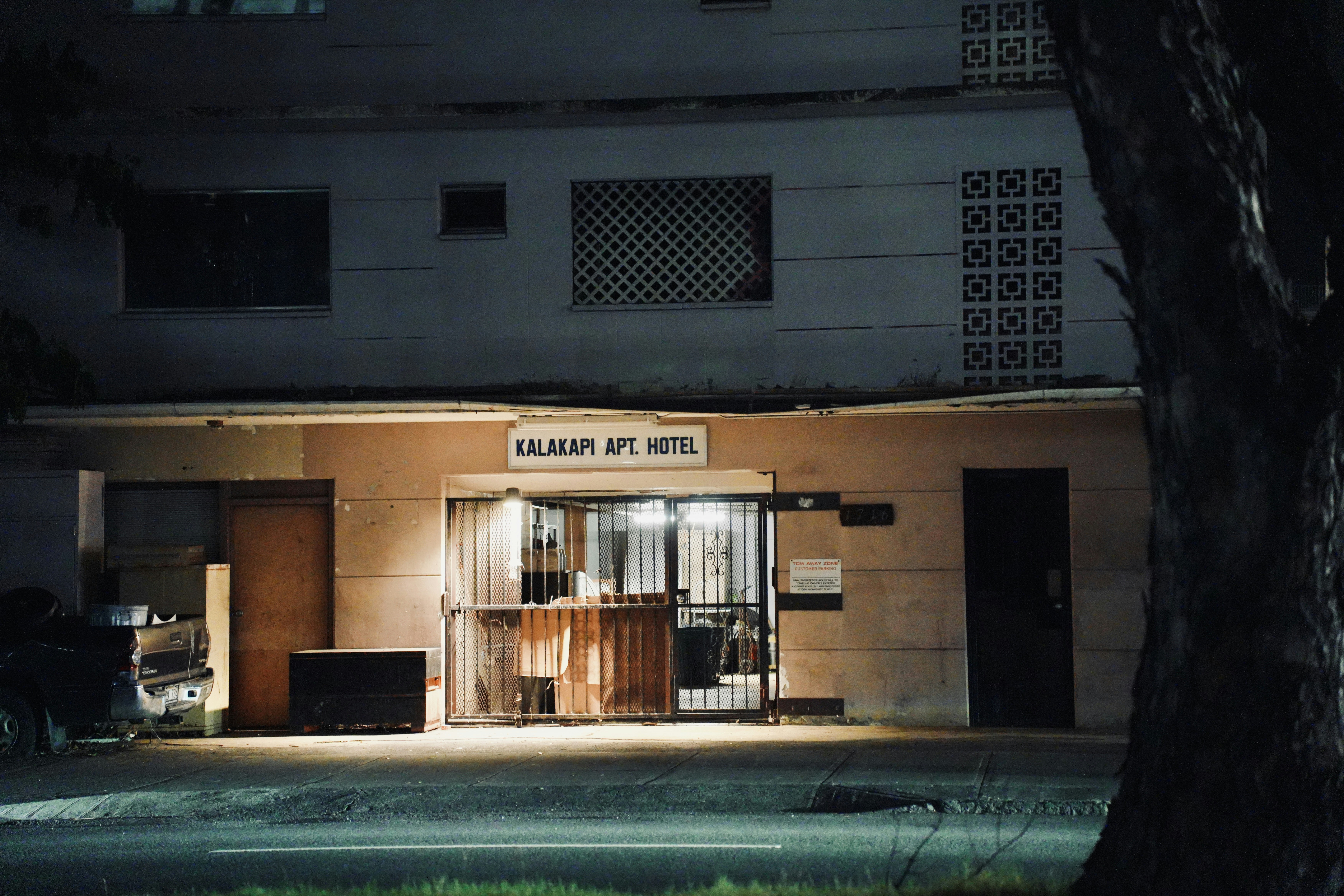A dimly lit apartment hotel entrance at night
