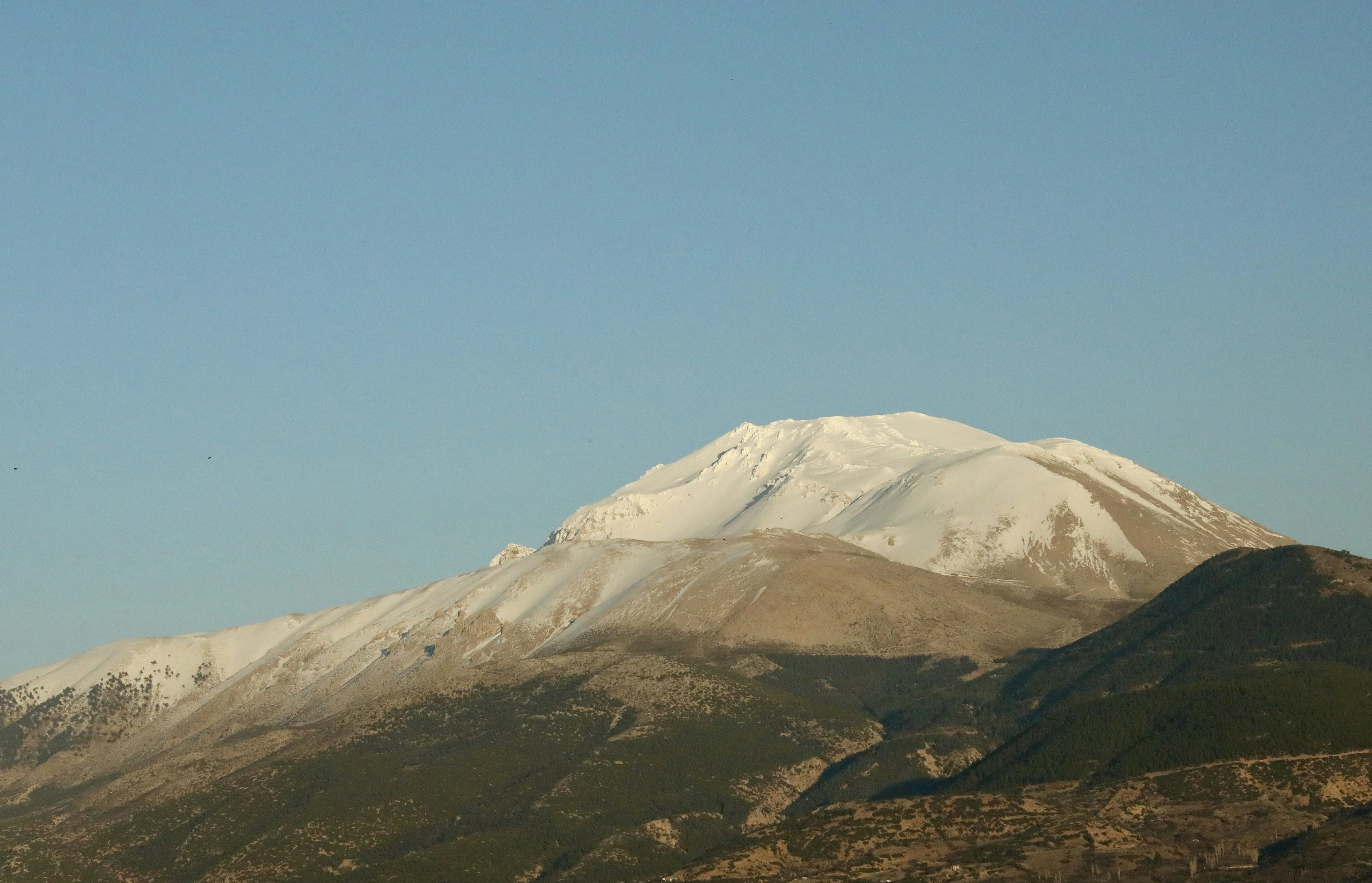 Snow-capped mountain peak under a clear blue sky