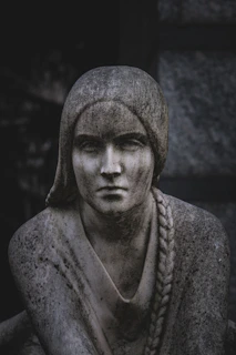 Stone statue of a woman with braided hair