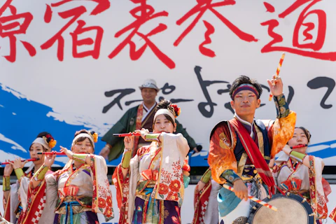 Performers in traditional japanese attire playing instruments