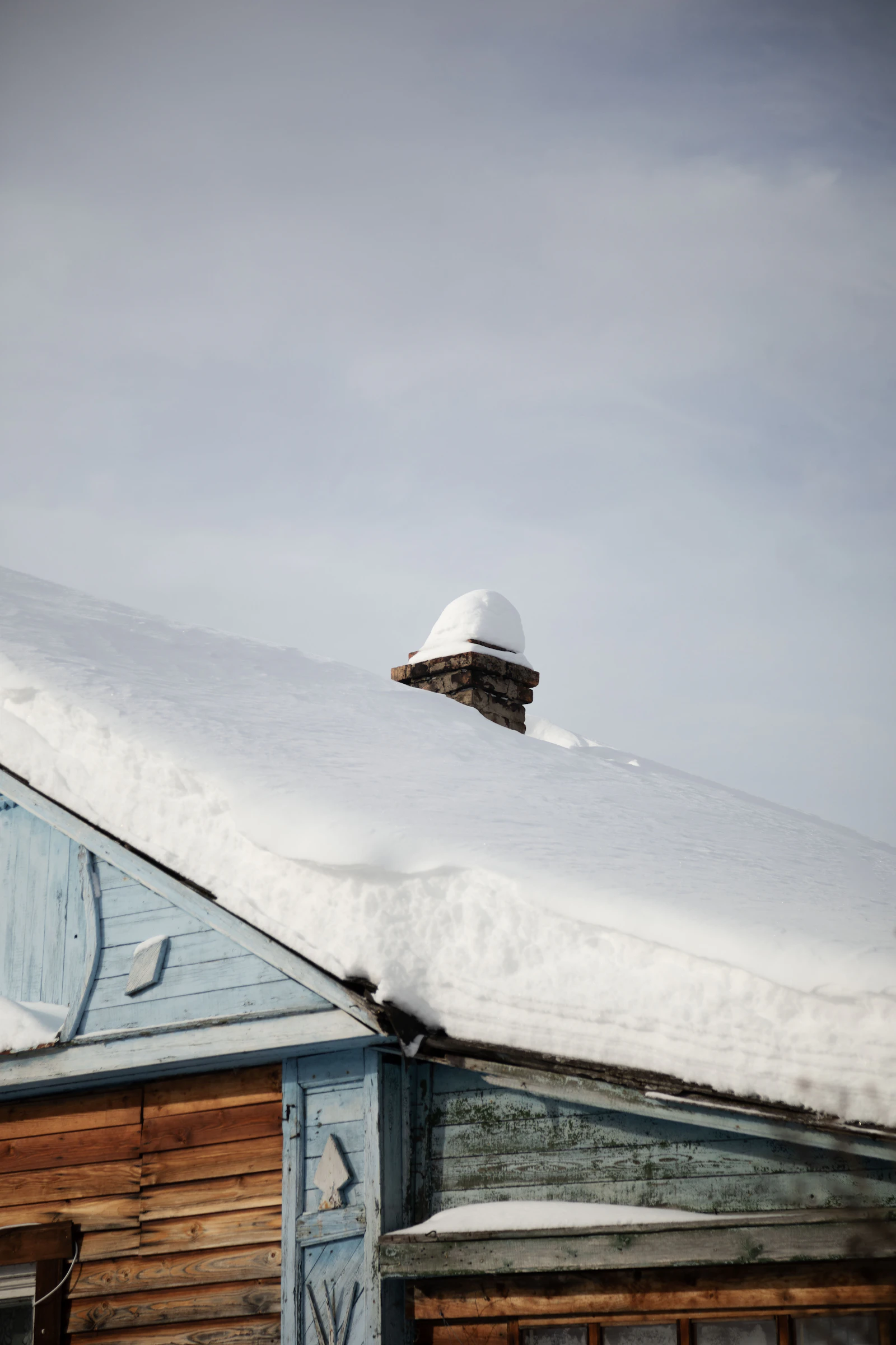 Snow-covered roof with chimney on a Joliet IL home in winter