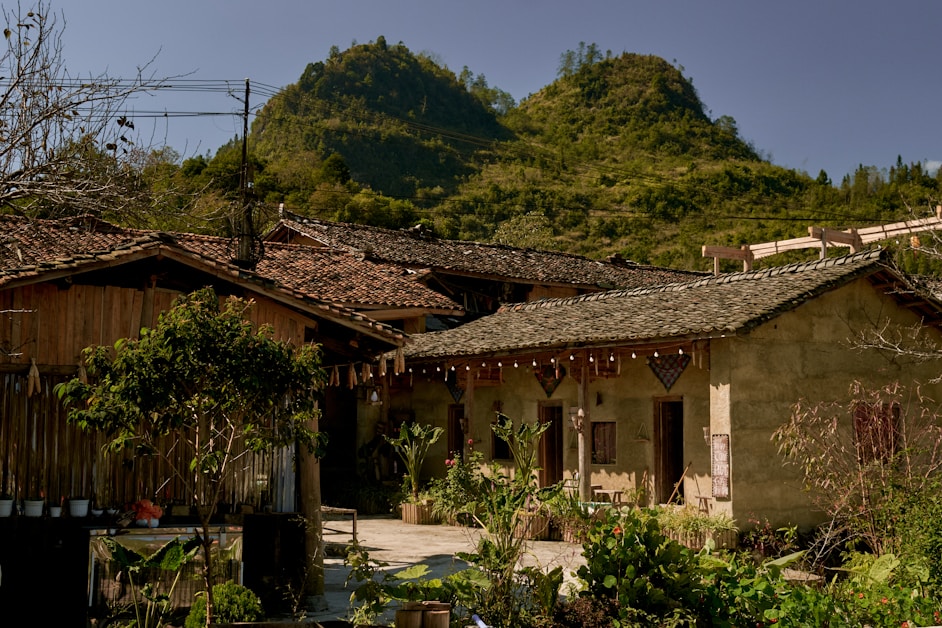 hidden villages china - traditional houses against green hills