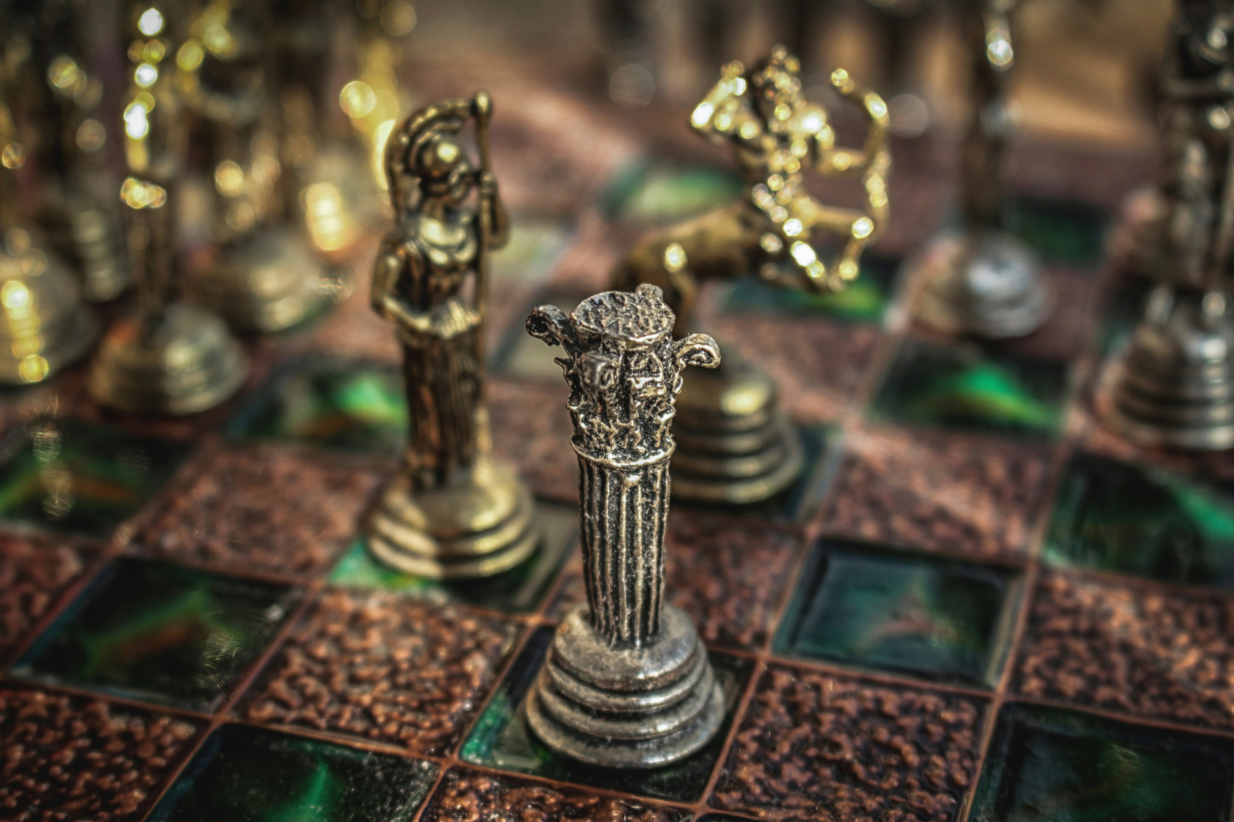 Antique chess pieces on a detailed board