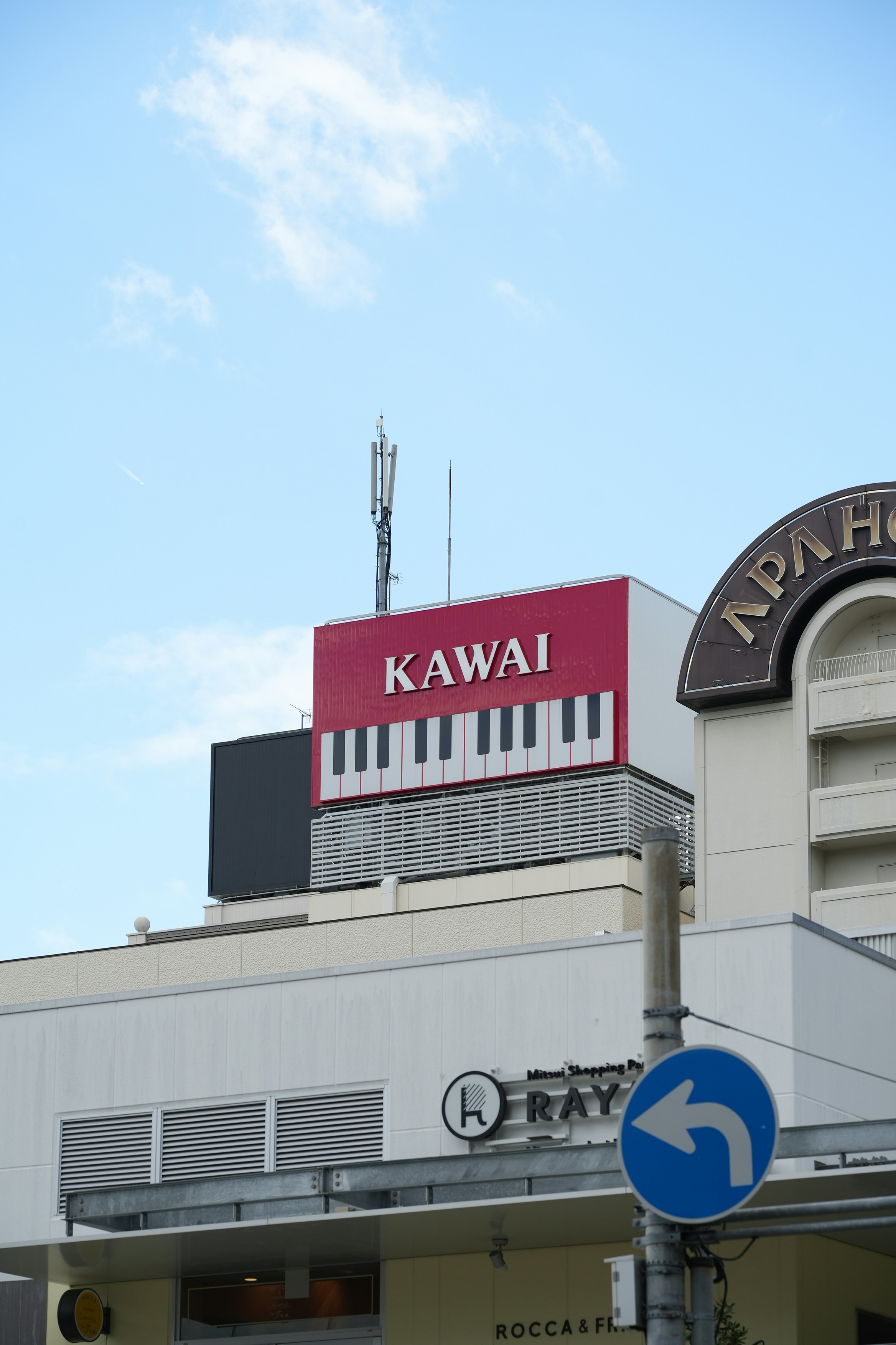 Building with kawai piano keys sign under blue sky
