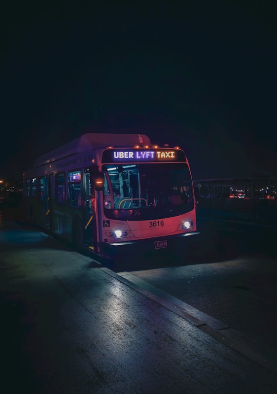 Bus with rideshare sign at night