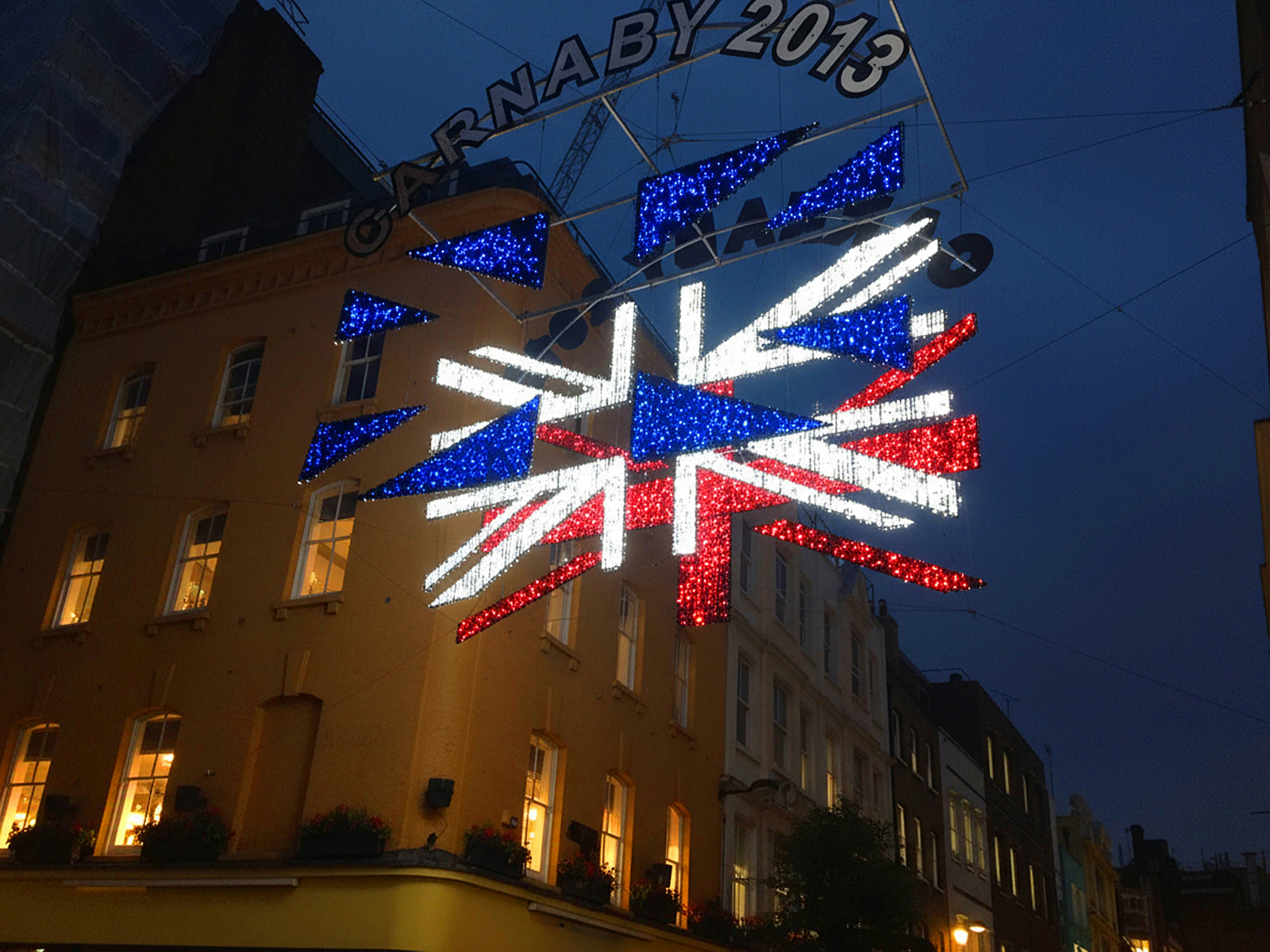 Union jack lights decorate street at night