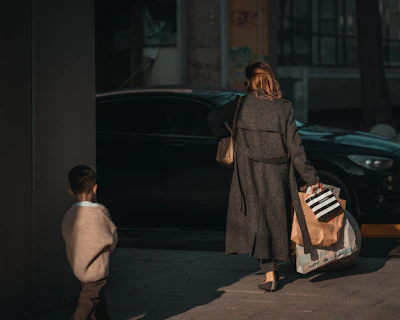 Woman and child walking with shopping bags.