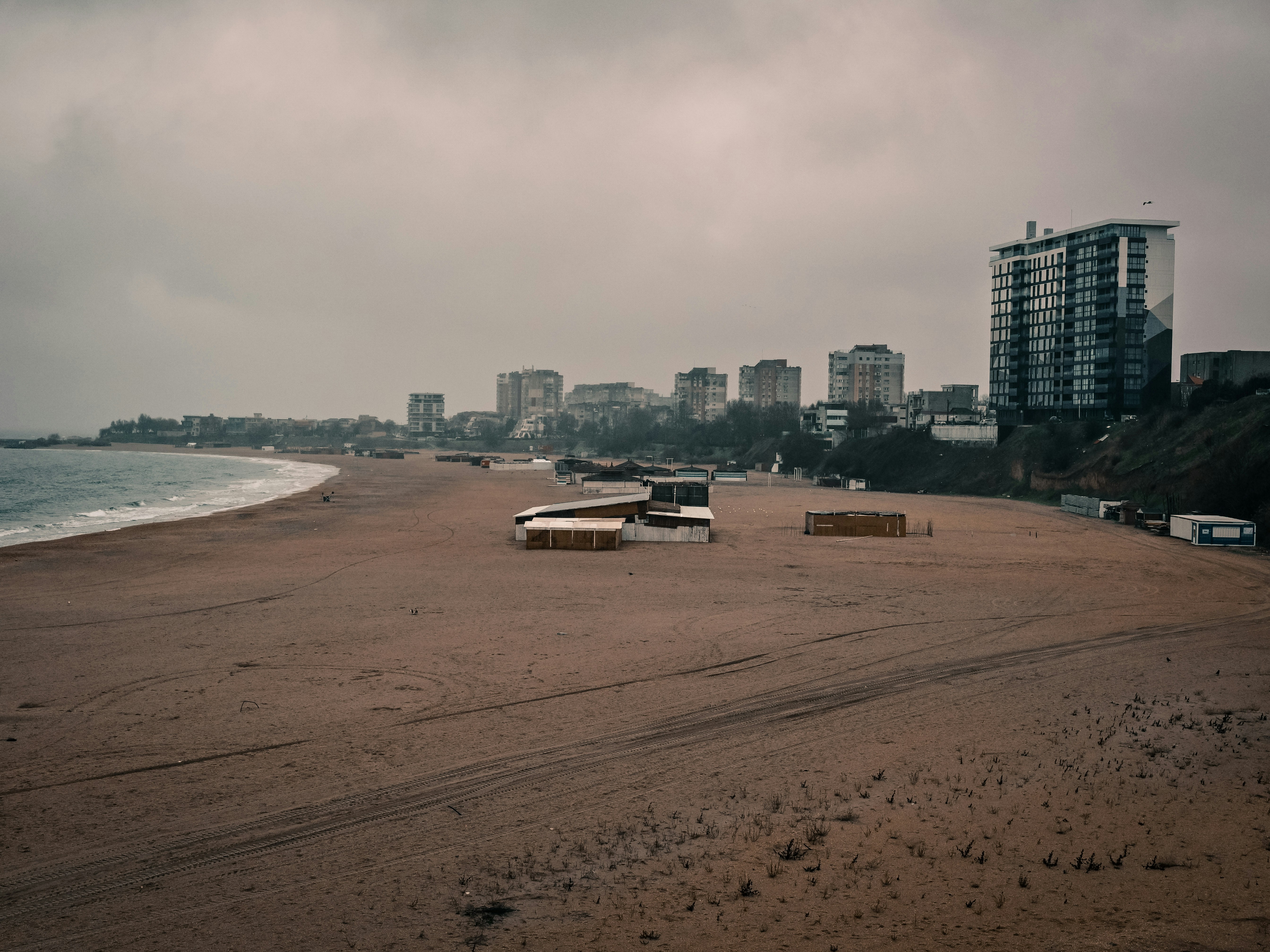 Empty beach with buildings in the background