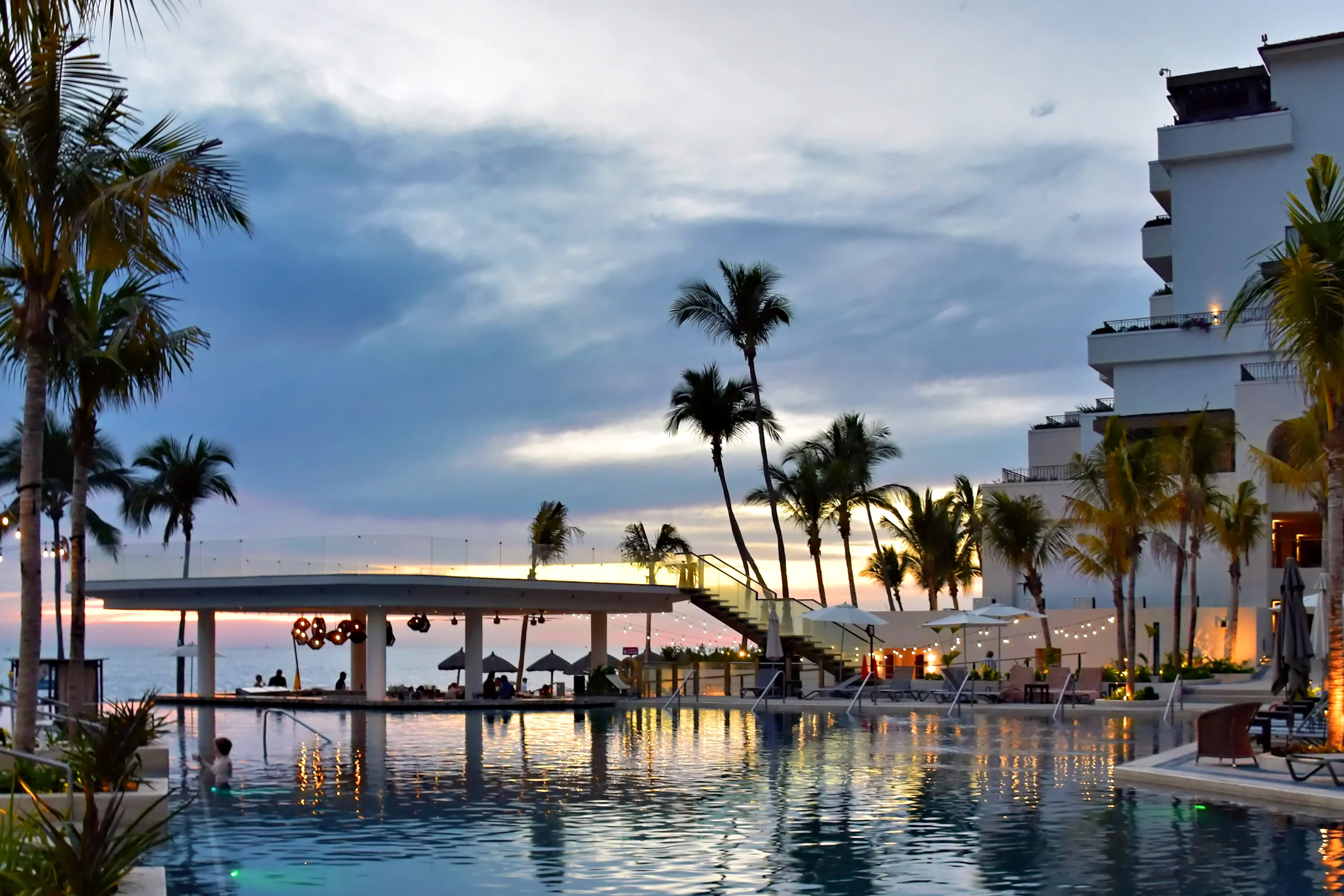 An infinity pool overlooking a sunset at a boutique stay
