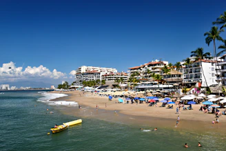 People relax on a sunny beach with ocean waves