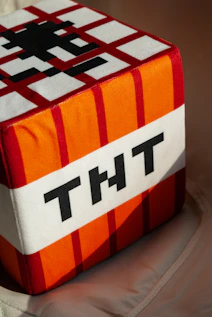 A plush tnt block with the letters tnt.