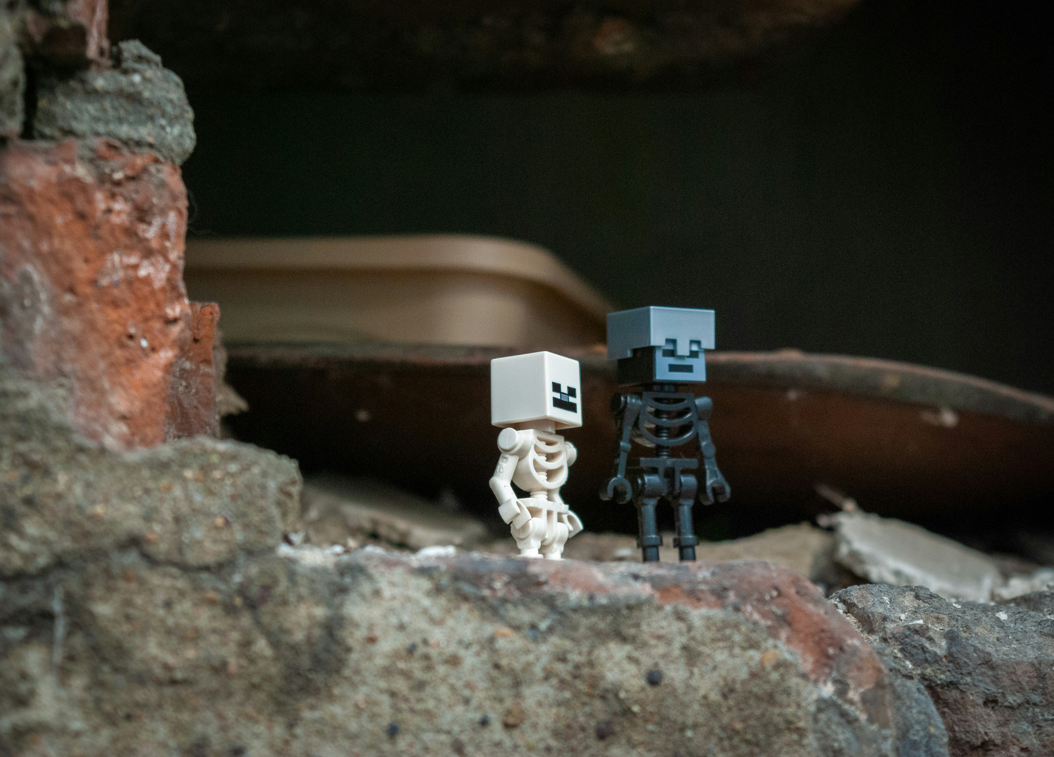 Two skeleton figures stand on rubble