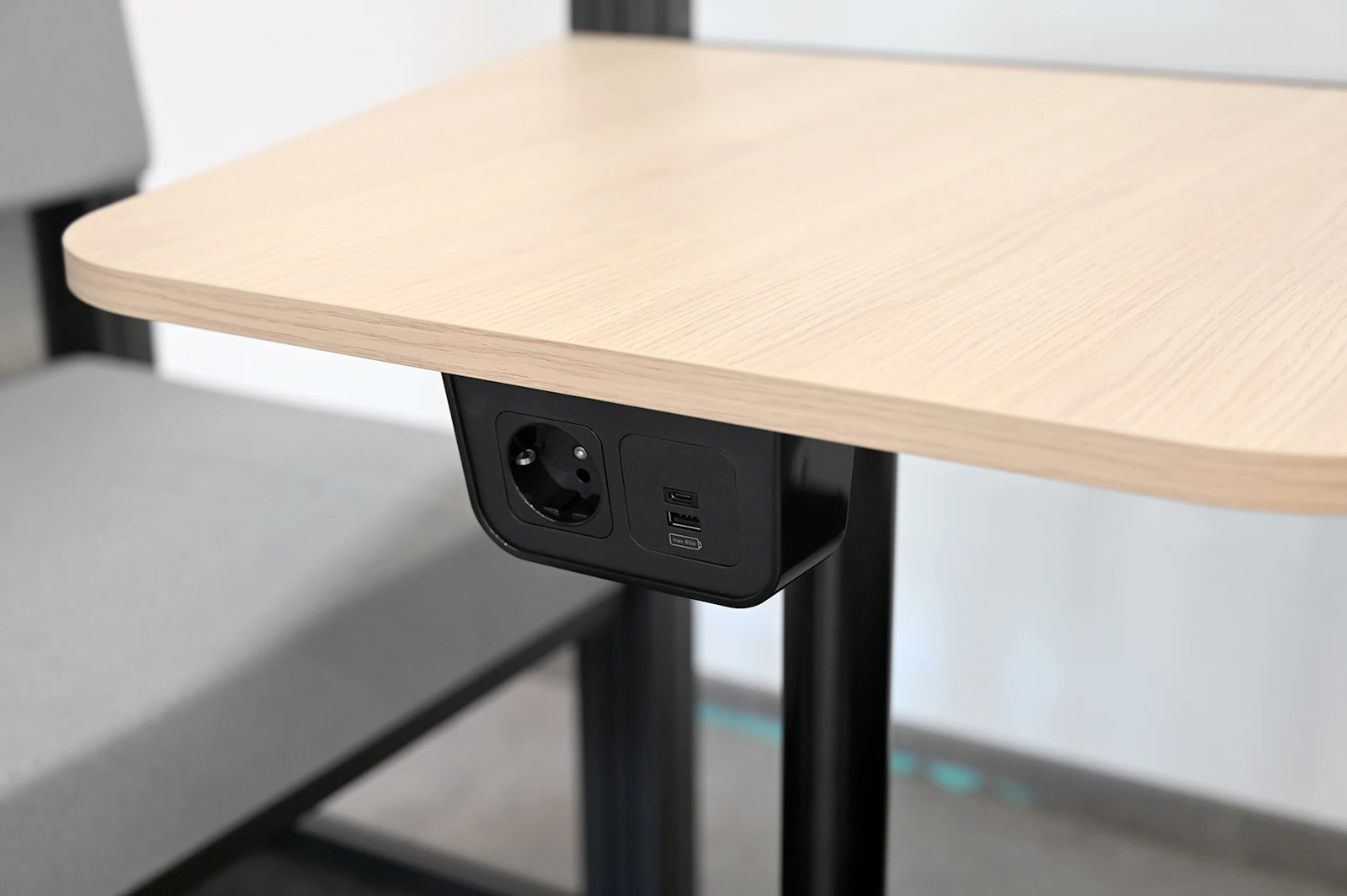 Integrated desk power outlet with USB charging ports