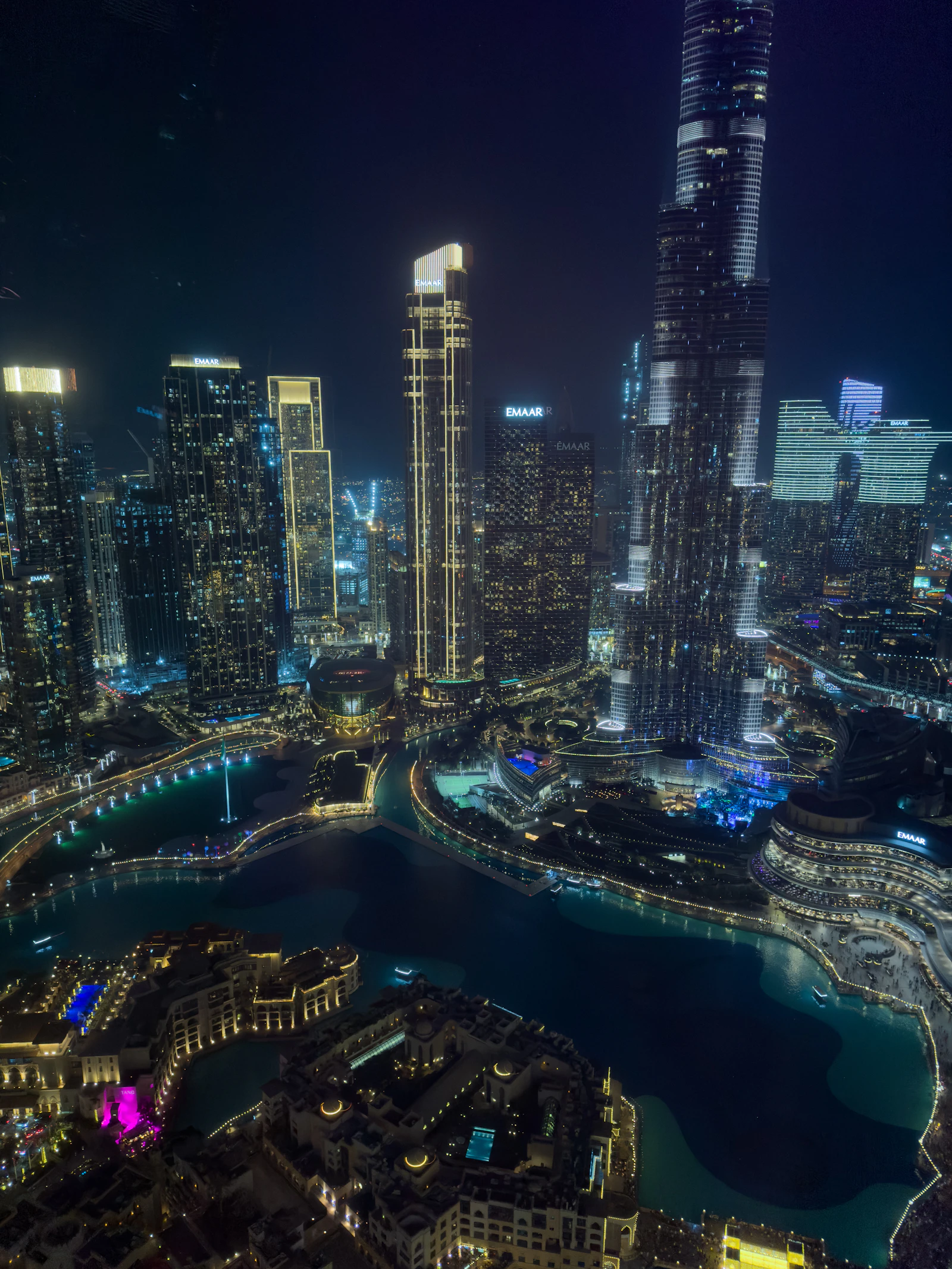 Dubai's illuminated skyline over water at night