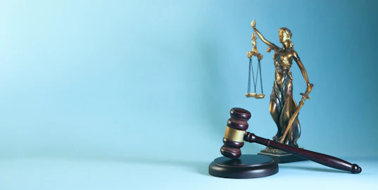 Lady justice and gavel on a blue background