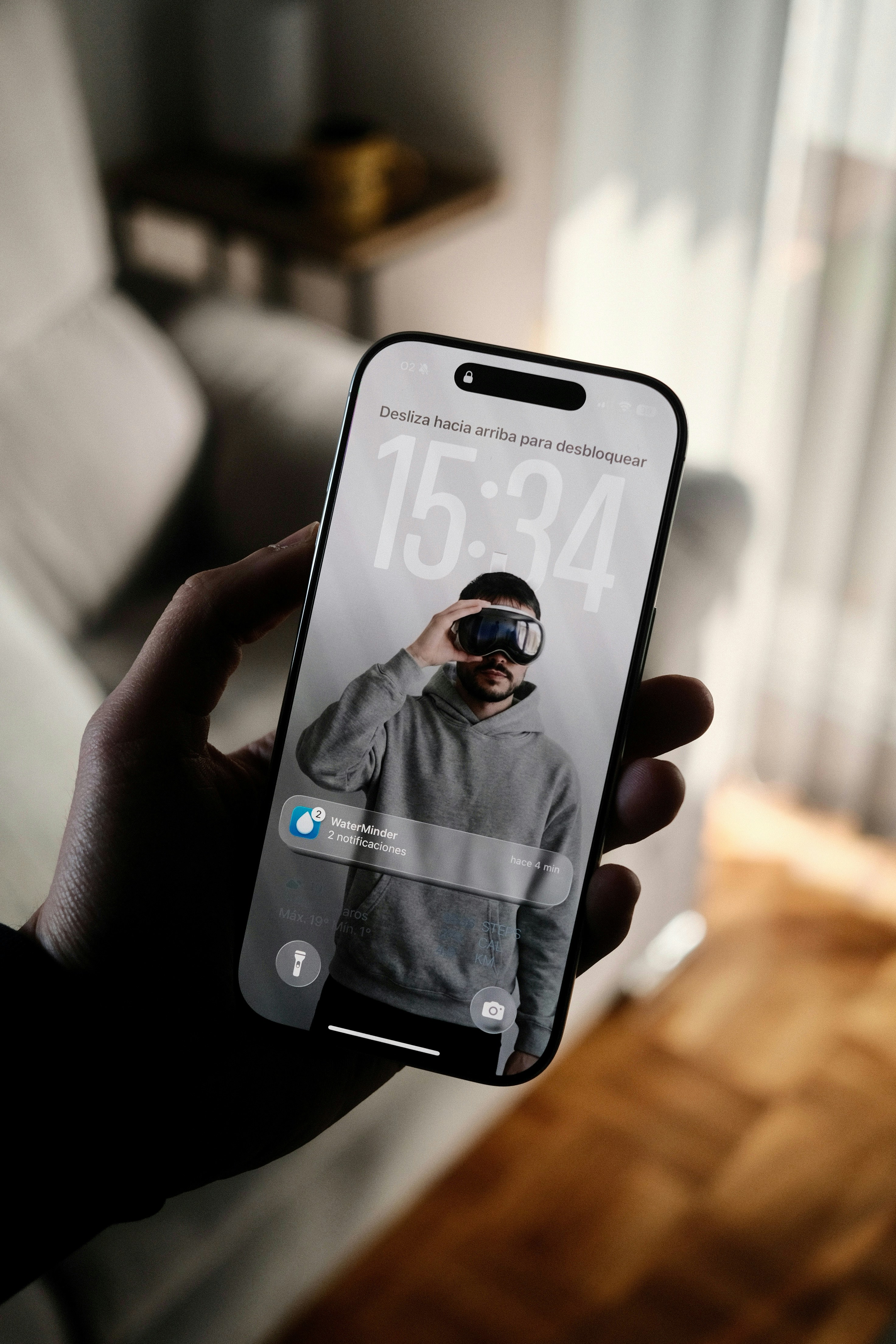 Person holding a smartphone with a vr headset on screen.