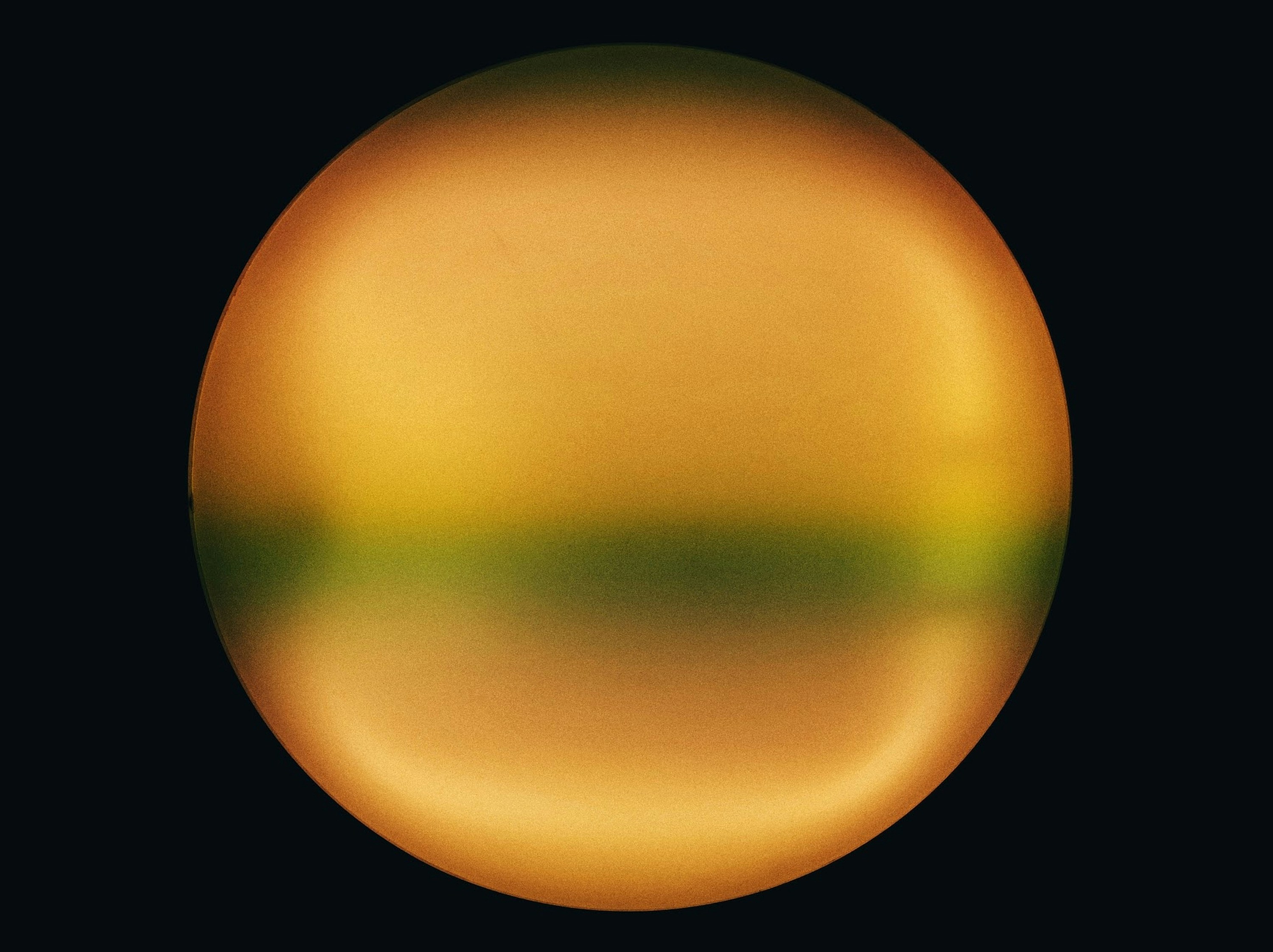 A golden sphere with reflections against a dark background