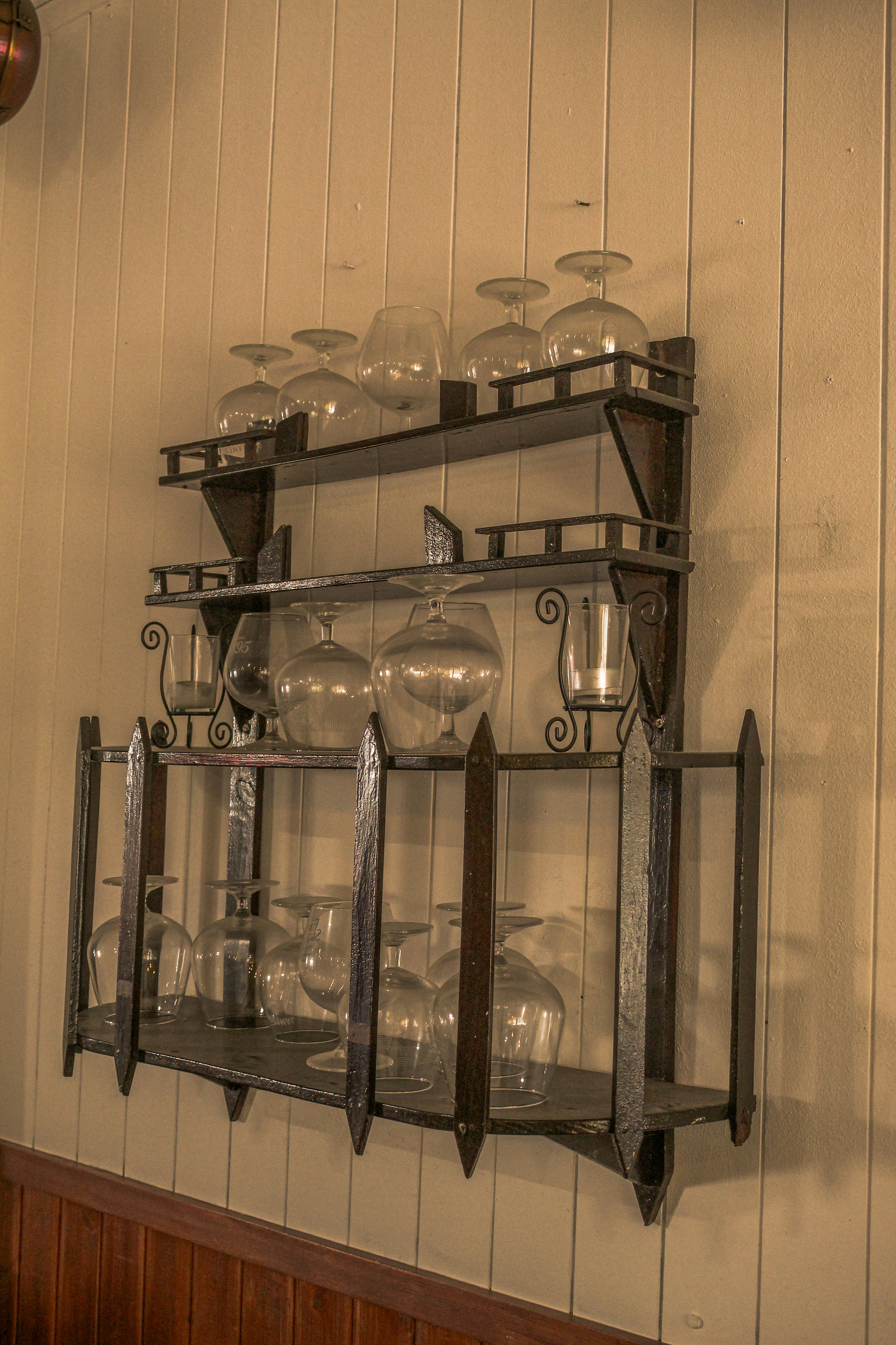 Wine glasses displayed on a rustic shelf