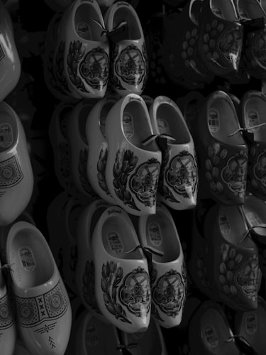 Rows of traditional Dutch wooden clogs displayed for sale in a shop