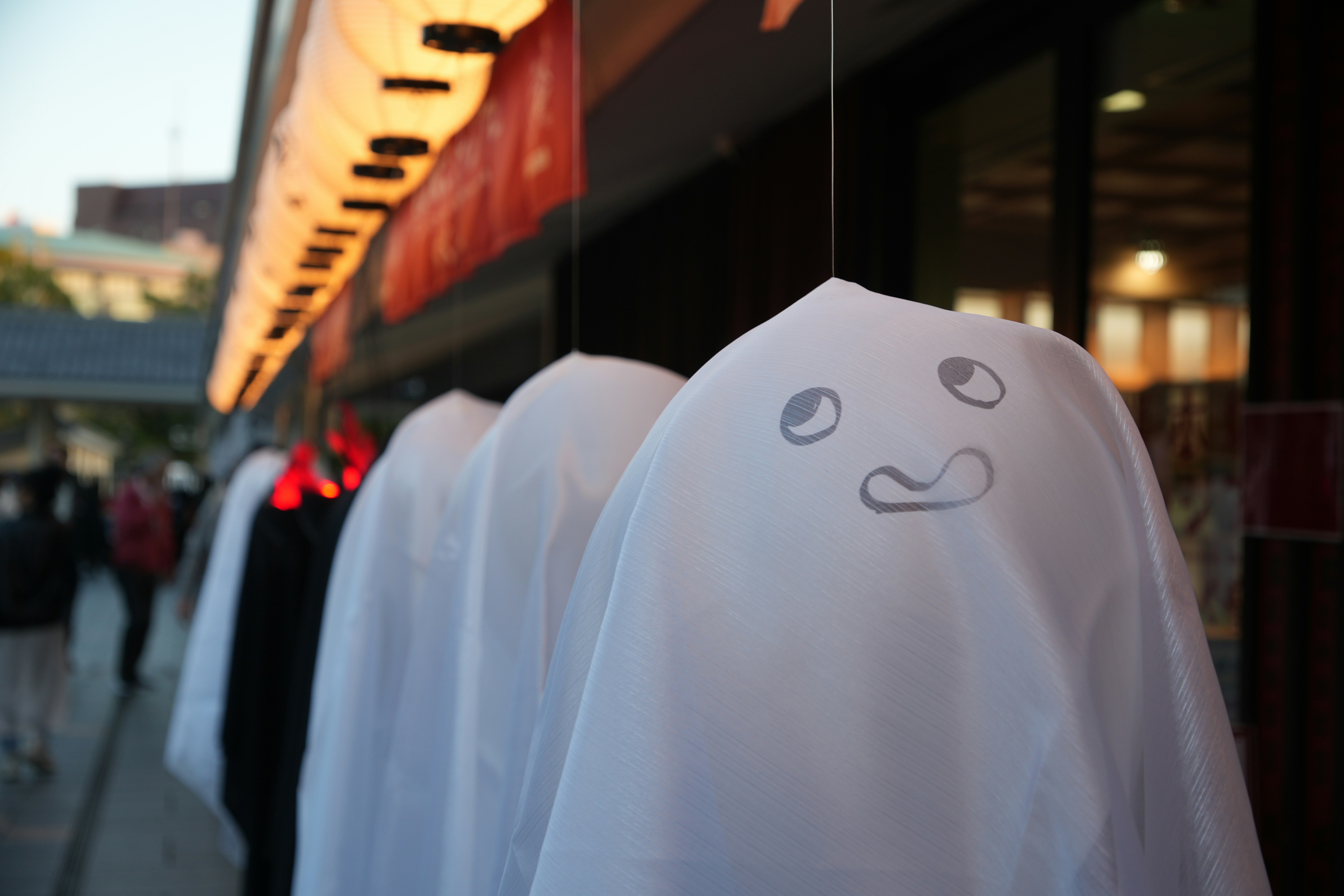 Row of white ghost decorations with faces