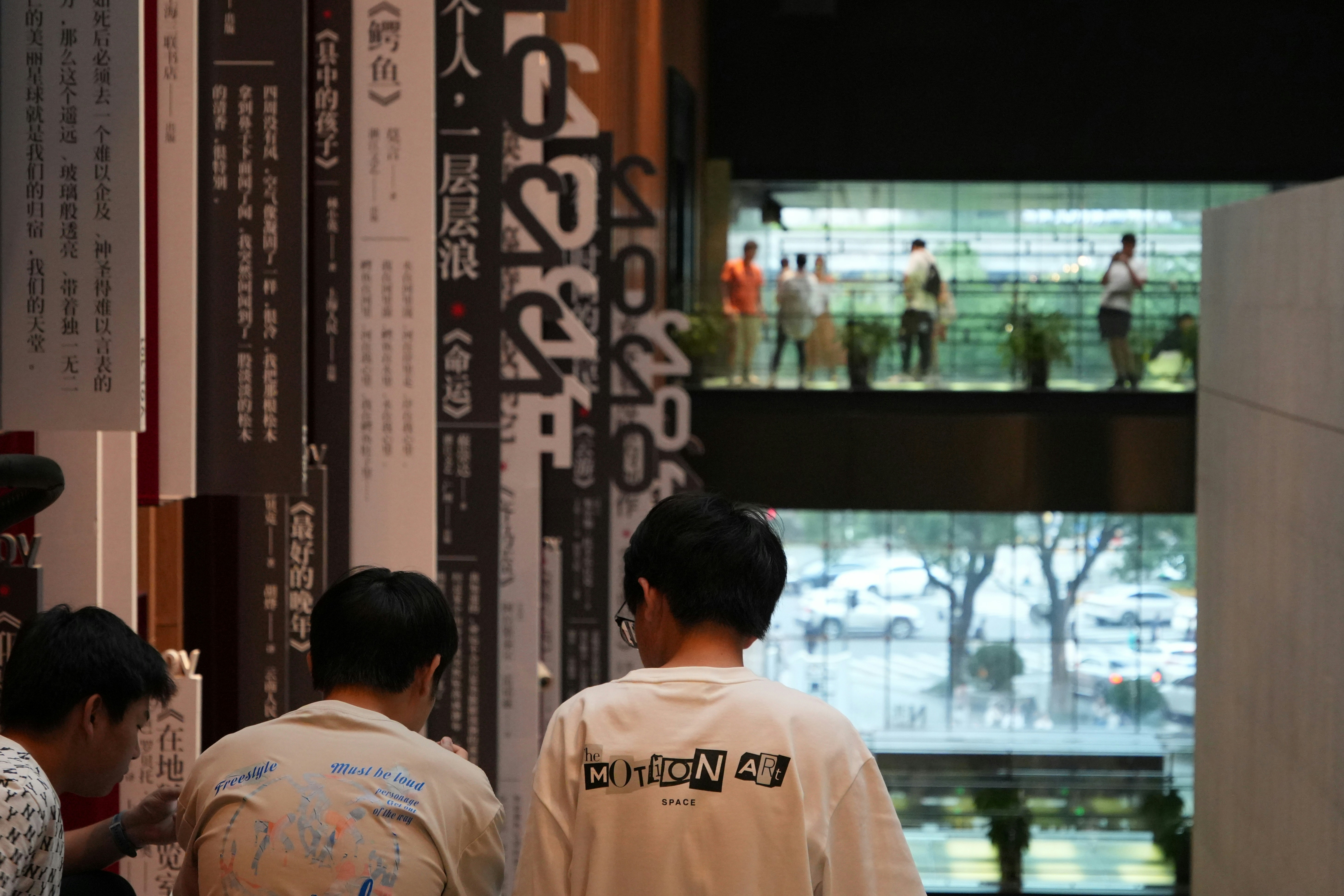 People looking at vertical displays with text