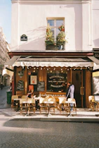 People sit at tables outside a parisian restaurant