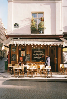 People sit at tables outside a parisian restaurant