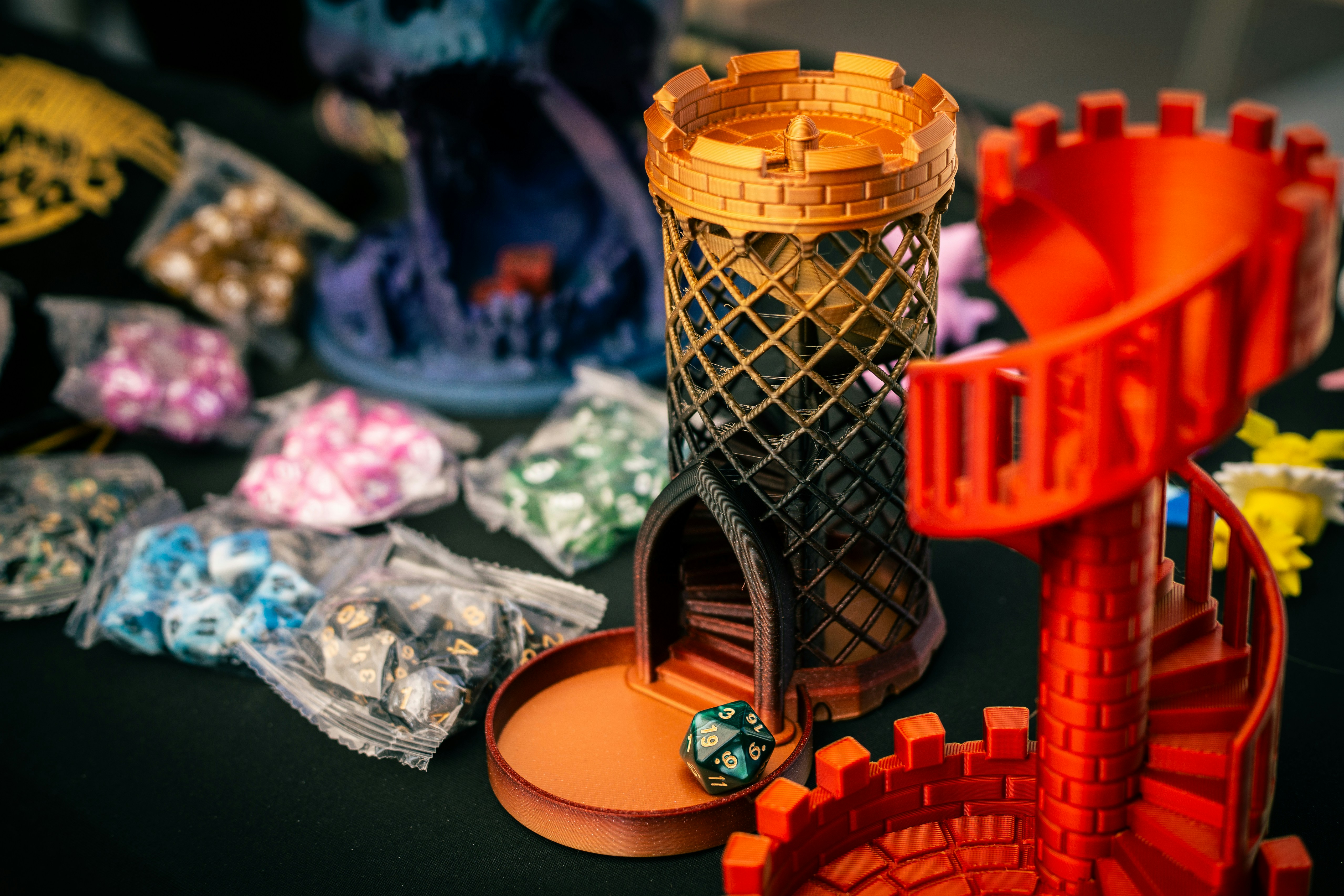 Dice towers and bags of dice on a table.