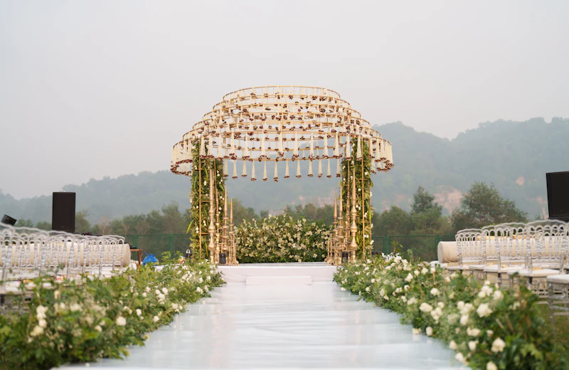 Decorated wedding arch with floral aisle and seating