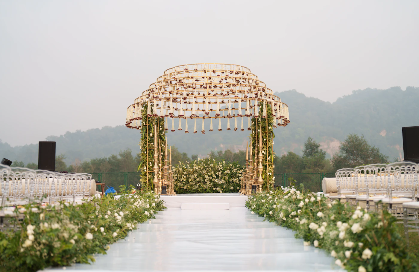 How to repurpose ceremony flowers for reception decor — A lush aisle arrangement gets carried to a reception table as a centerpiece