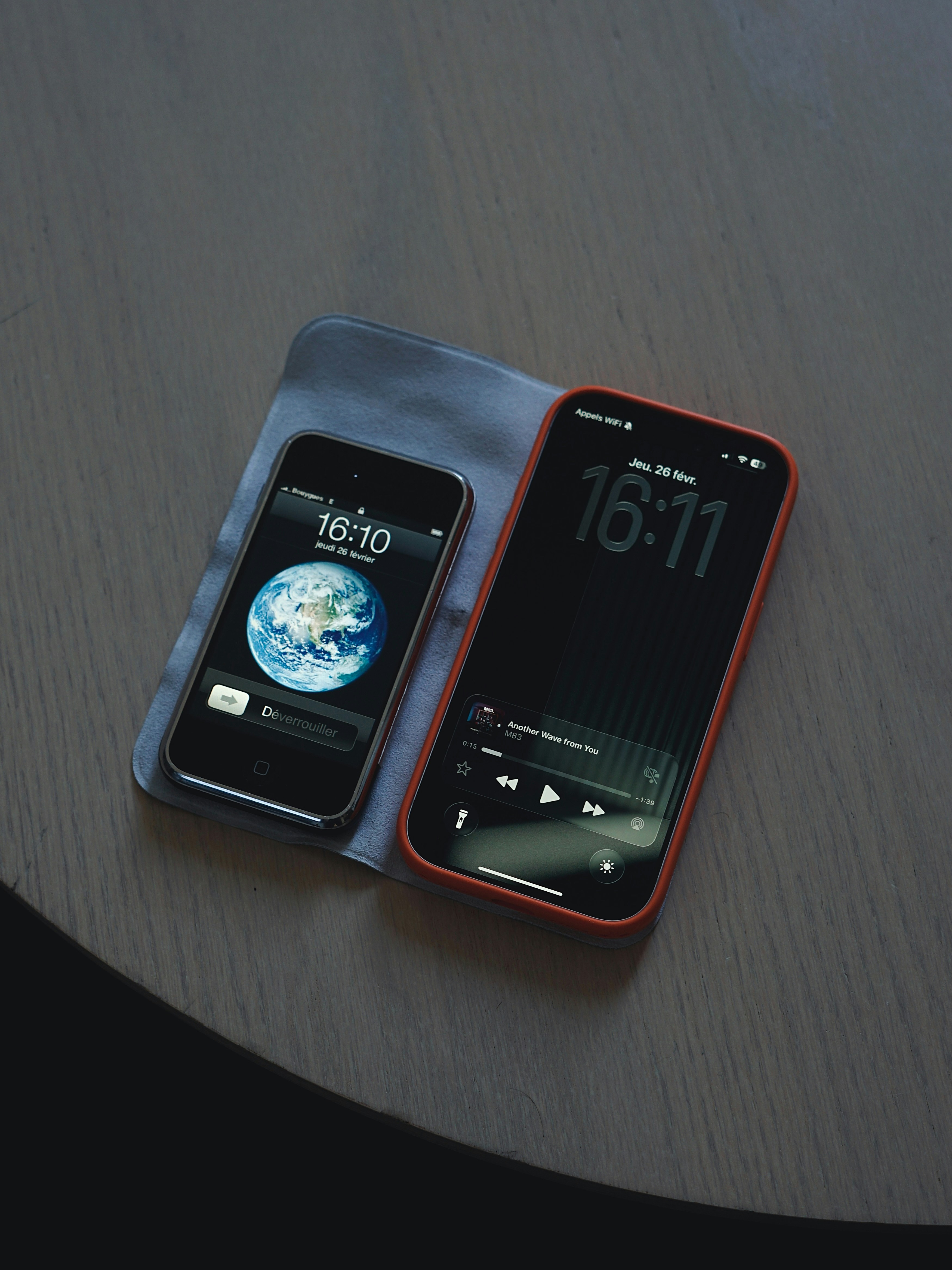 Two smartphones displaying the time on a table